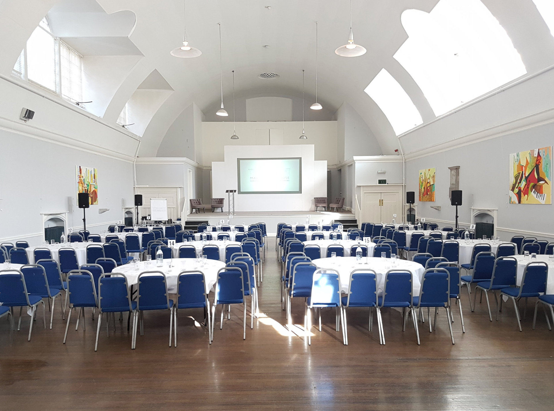 Mary Ward Hall event venue with round tables, ideal for corporate meetings and workshops.