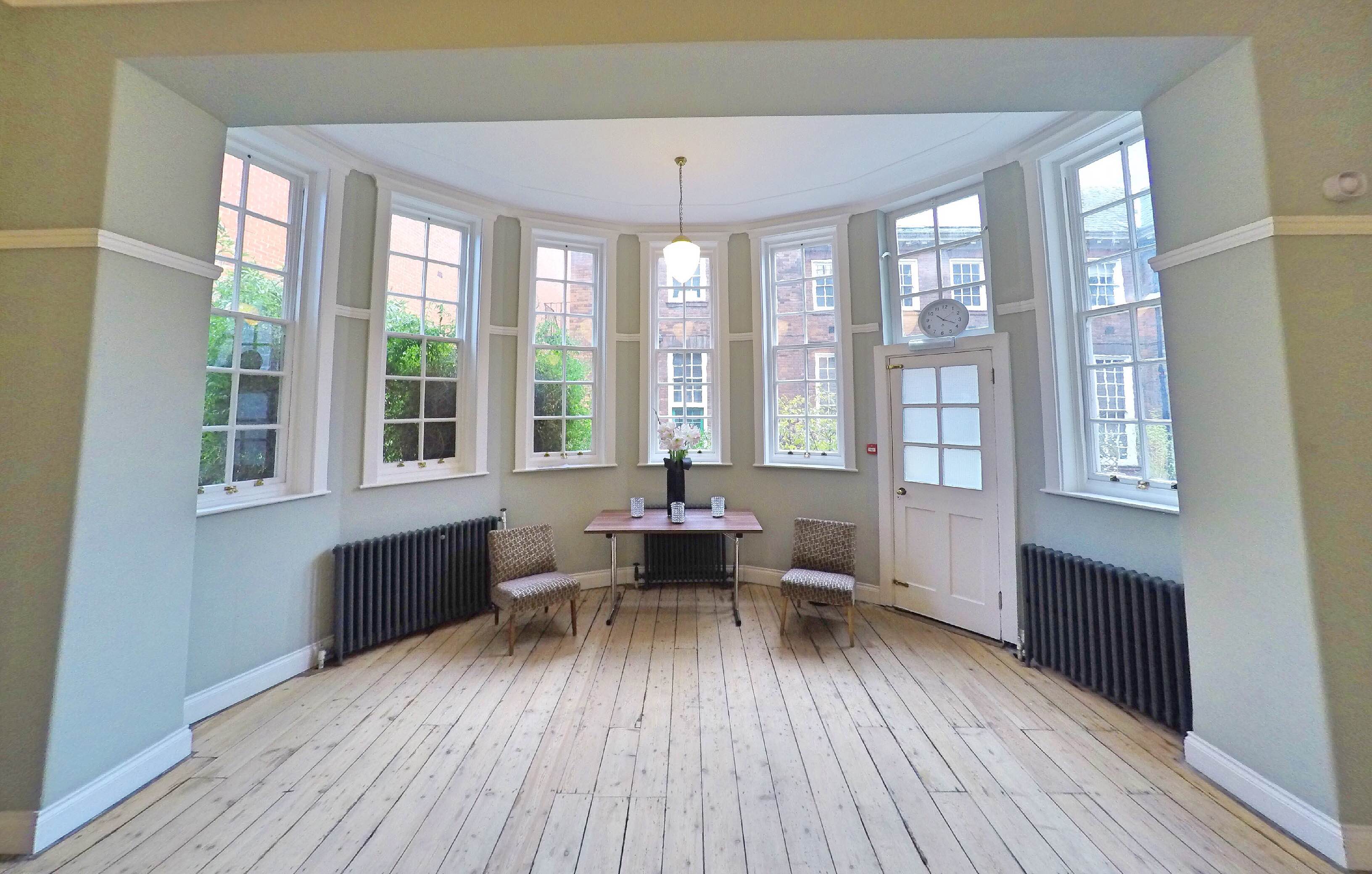 Voysey Room at Mary Ward House: bright meeting space with large windows for gatherings.