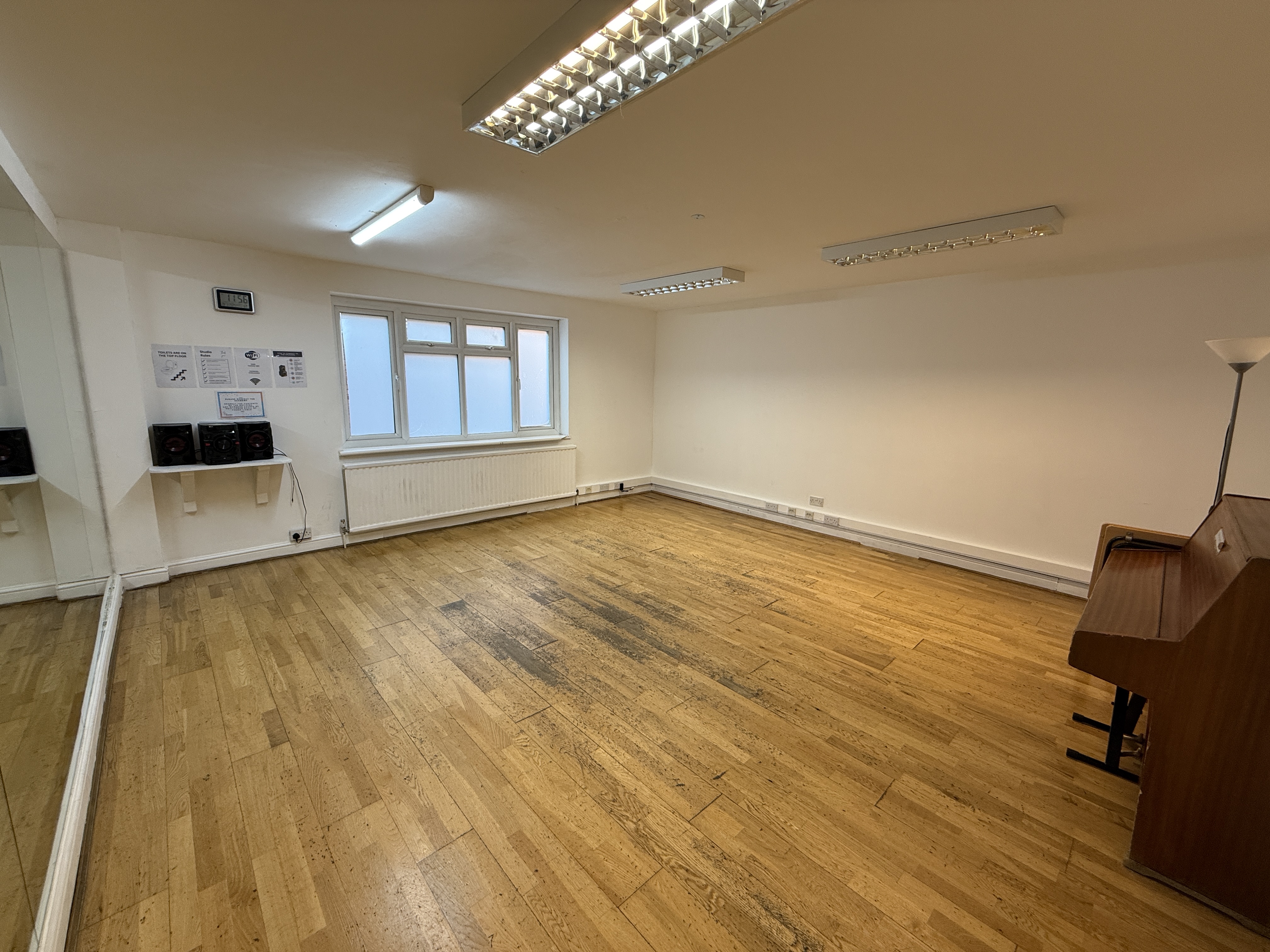 Versatile meeting space with natural light and wooden flooring at The Solo Studio, artsHouse.