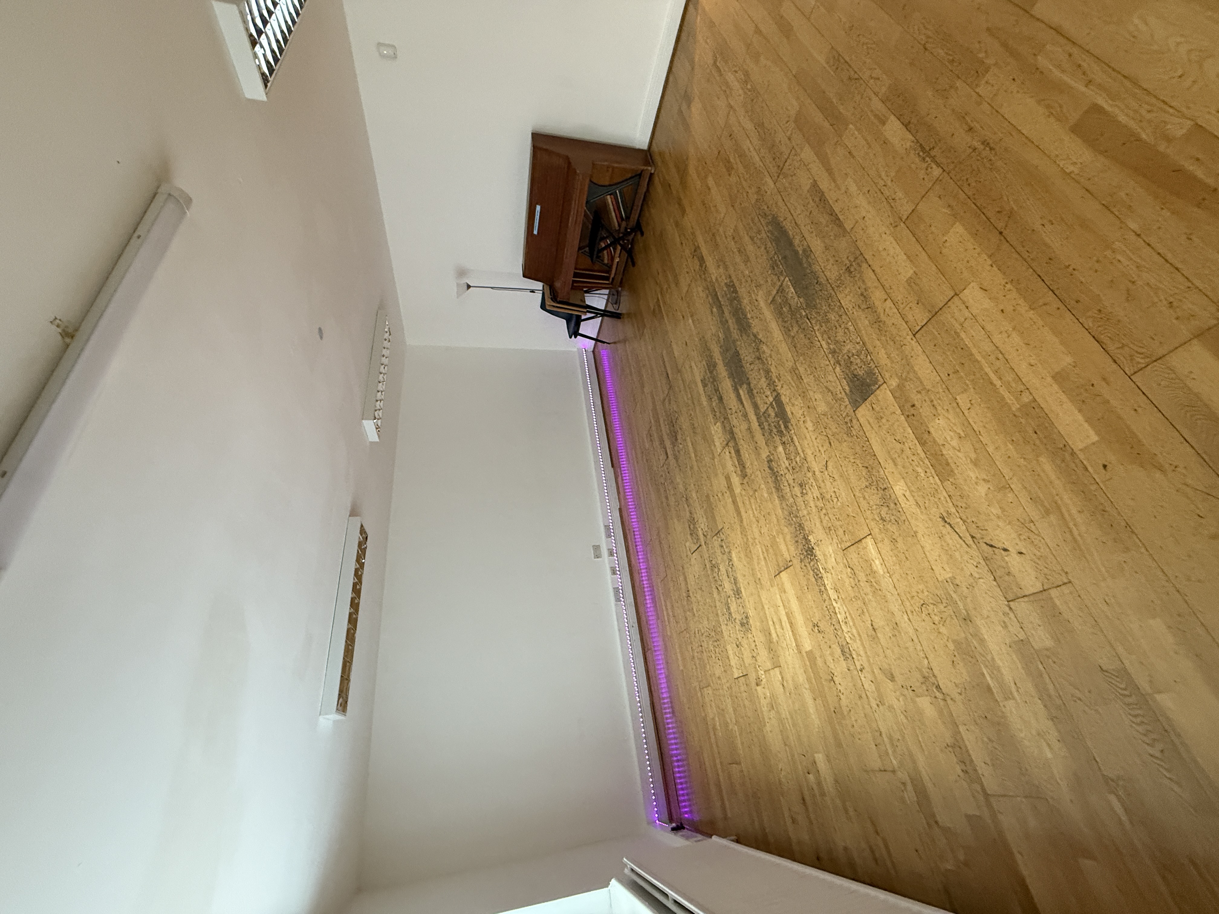 Versatile event space with wooden flooring, ideal for intimate gatherings and workshops.