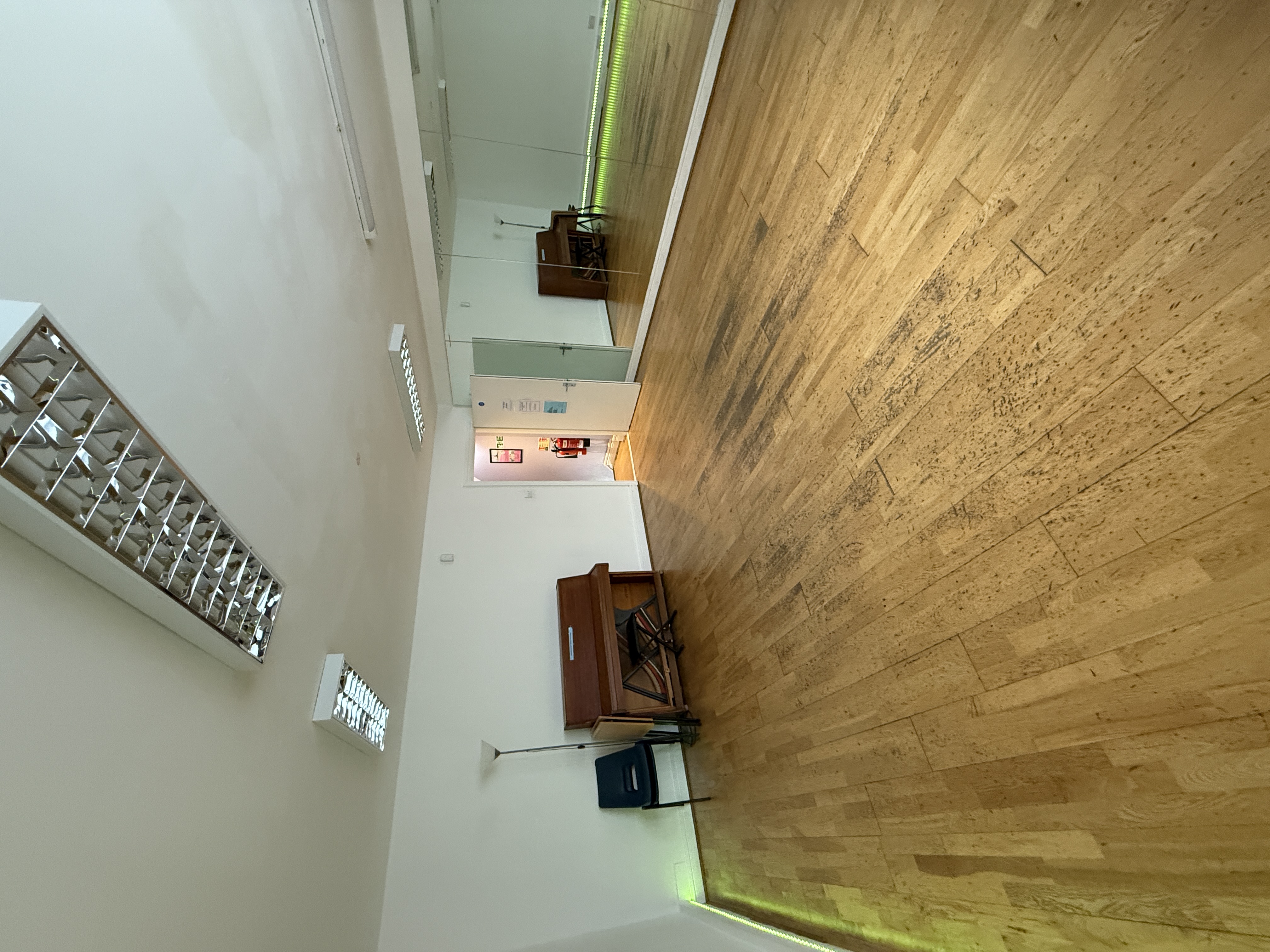 Versatile meeting space with piano, ideal for workshops and gatherings at artsHouse.