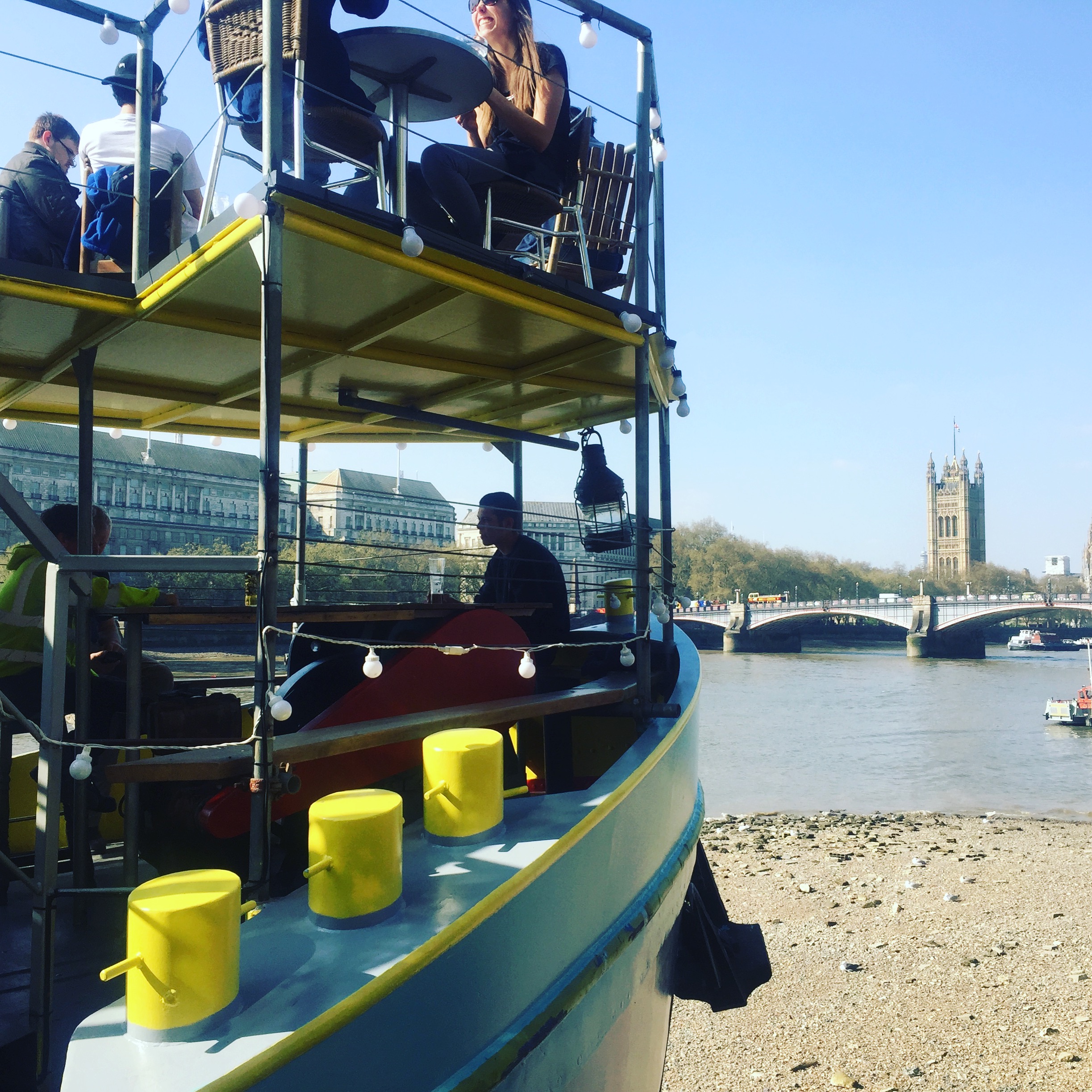 Outdoor venue on River Thames, vibrant boat setup for creative events and networking.