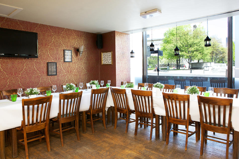 Elegant dining space at The Gallery in Wine Tun for private events, featuring fresh greenery.