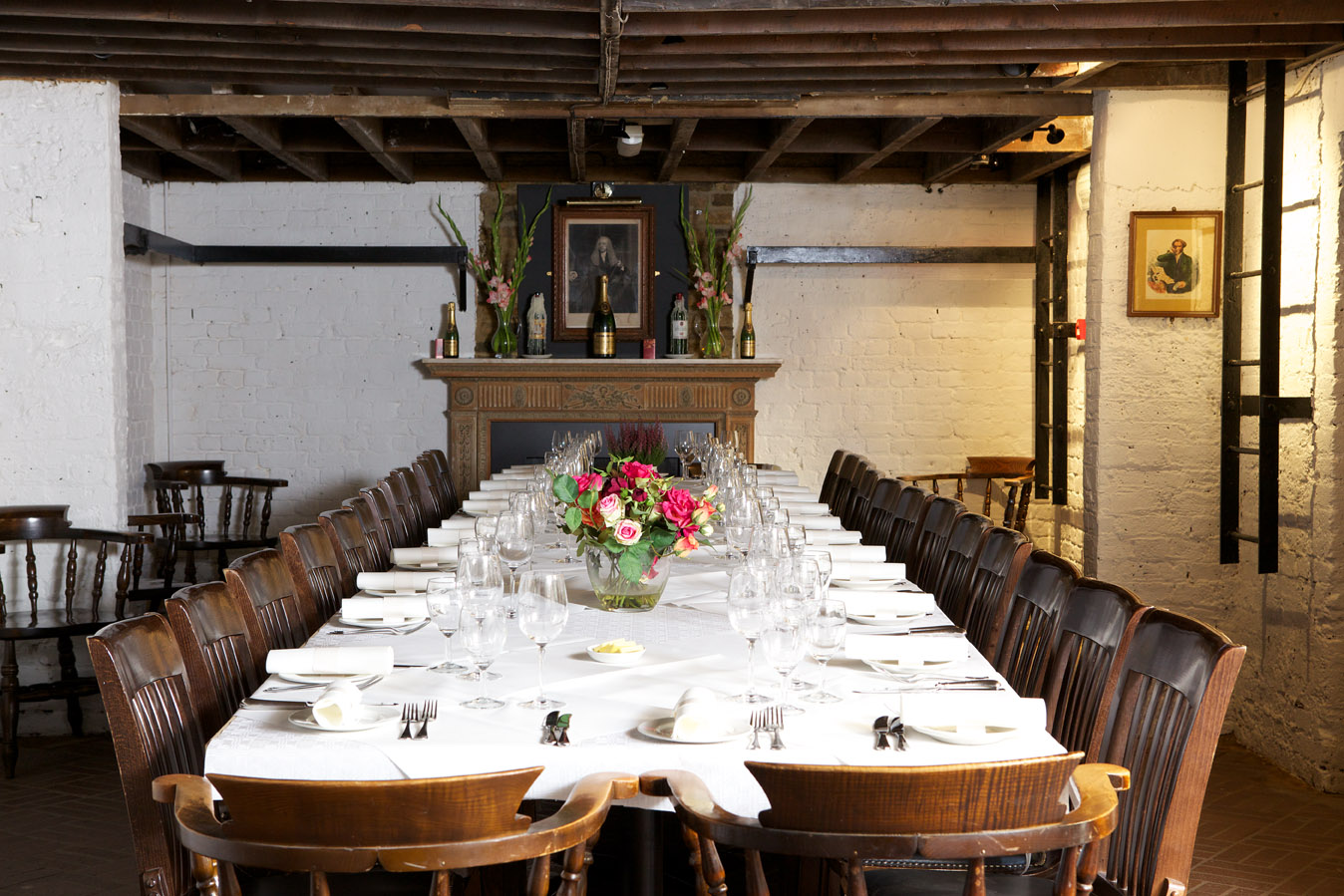 Elegant long dining table in rustic Boot and Flogger venue for intimate gatherings.