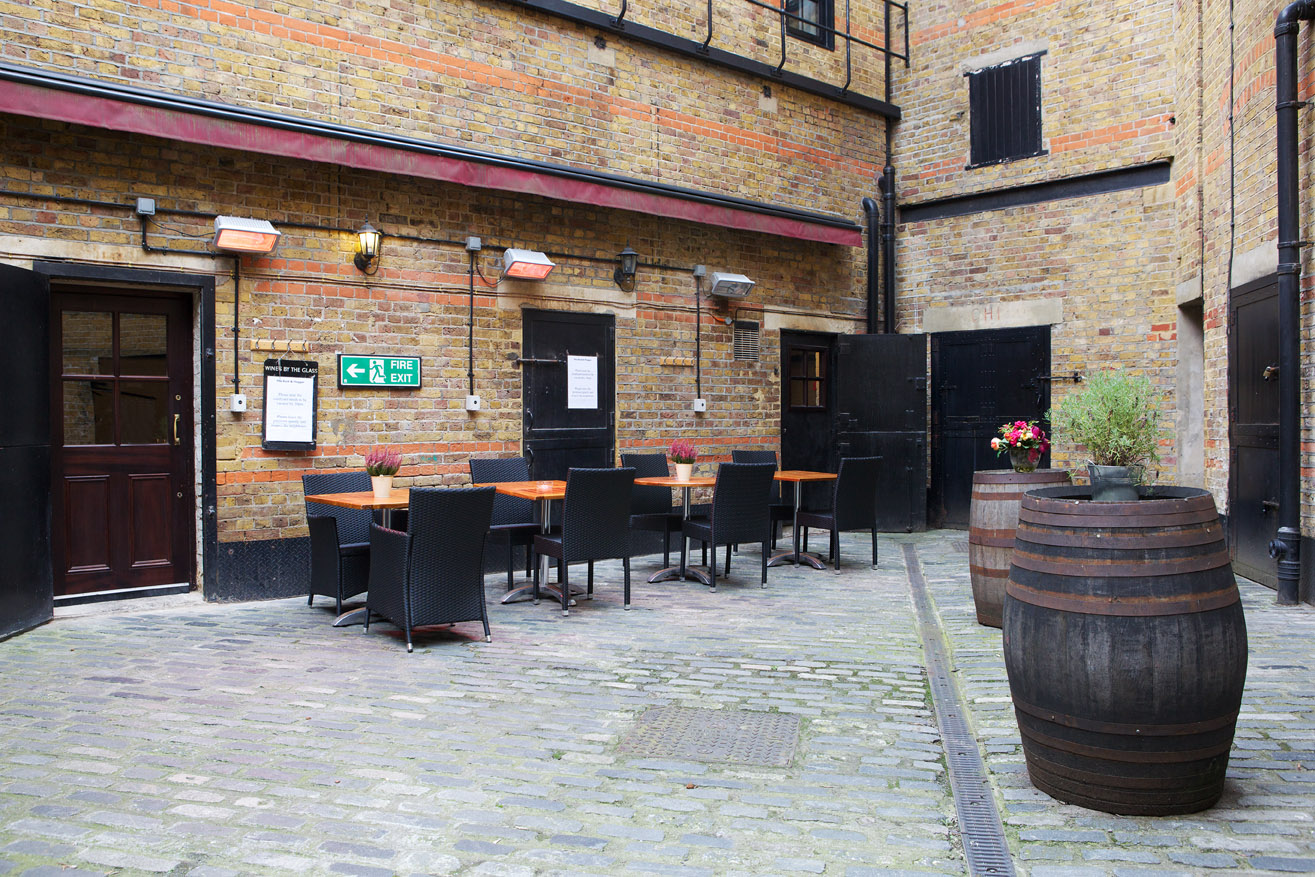 Charming outdoor courtyard at Boot and Flogger for intimate gatherings and networking events.