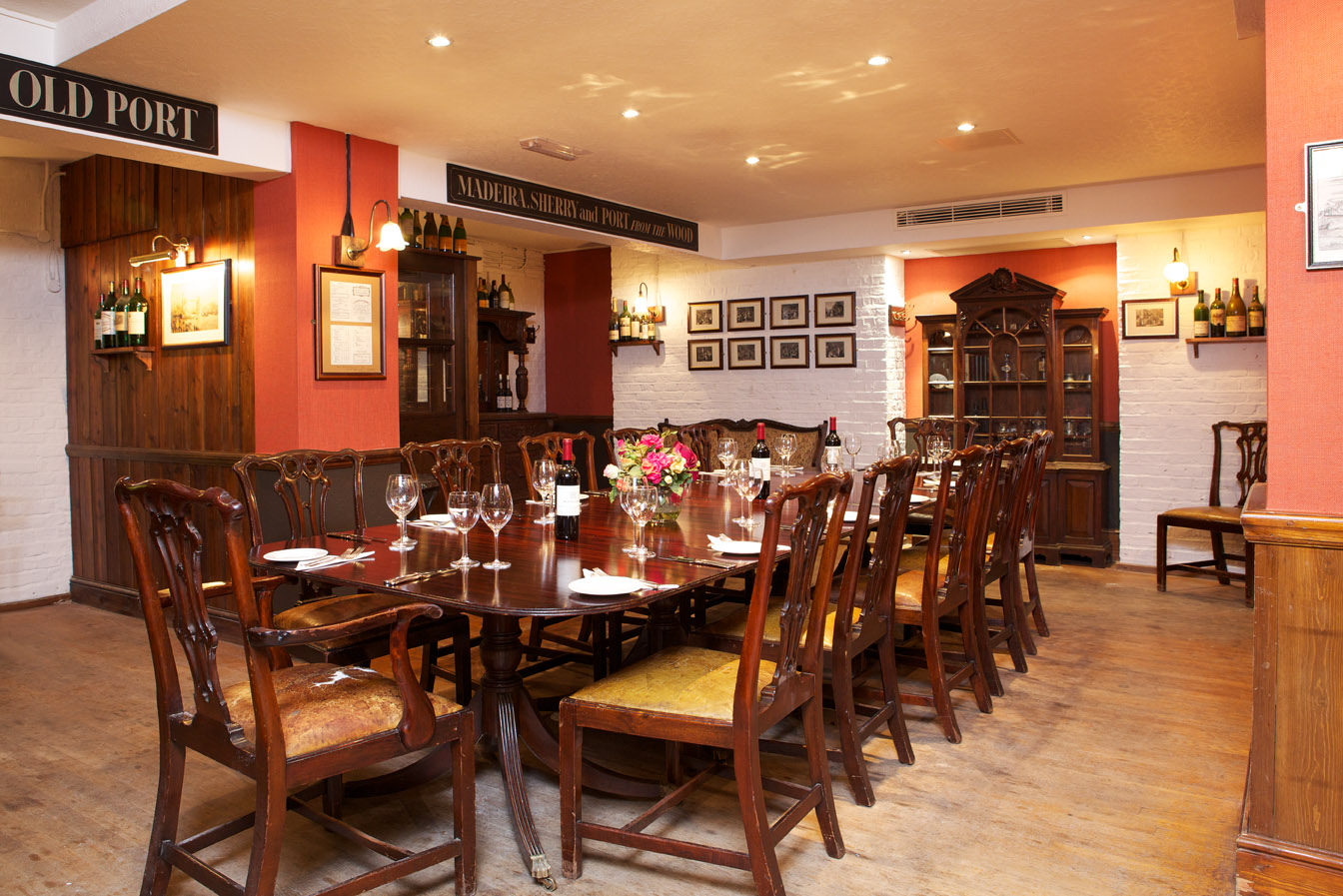 Elegant Red Room at Boot and Flogger, ideal for intimate corporate dinners and events.