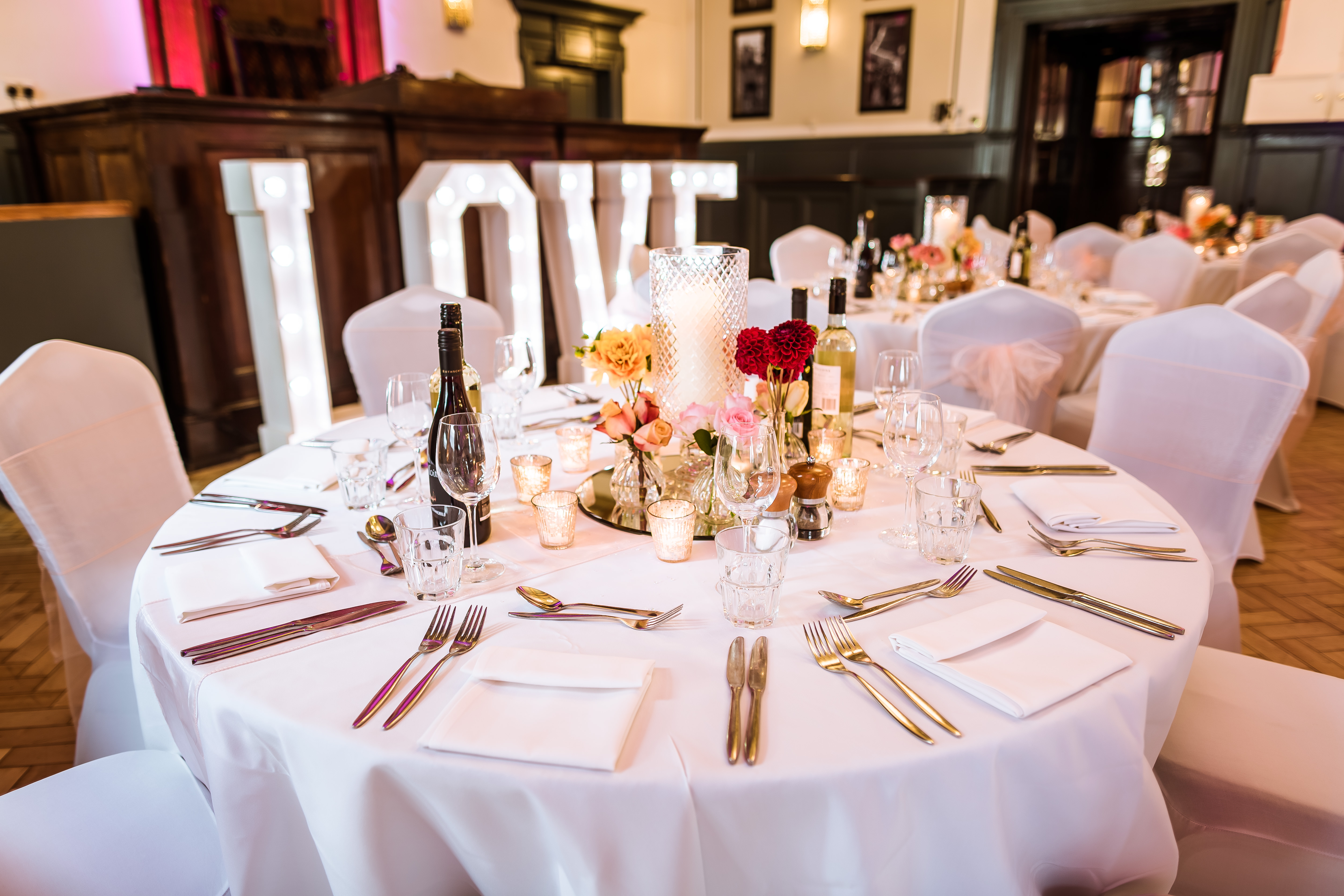 Elegant round table setup with floral arrangements at Spey Bar, perfect for weddings.