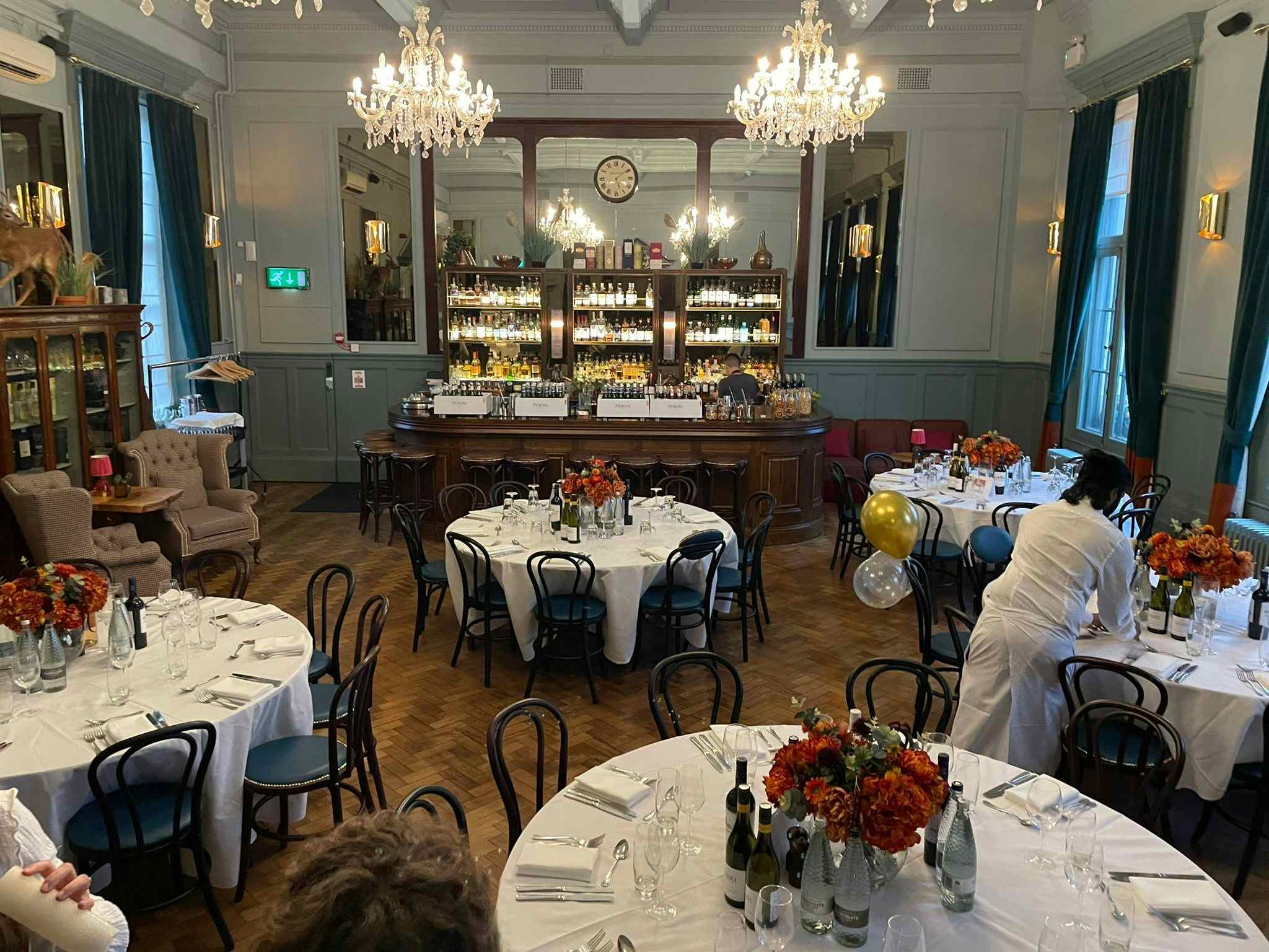 Elegant event space at Spey Bar, Browns Covent Garden, with floral centerpieces and warm lighting.