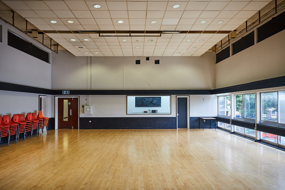 Main Hall at Mill Co. Rose Lipman, bright event space with hardwood floor for meetings.