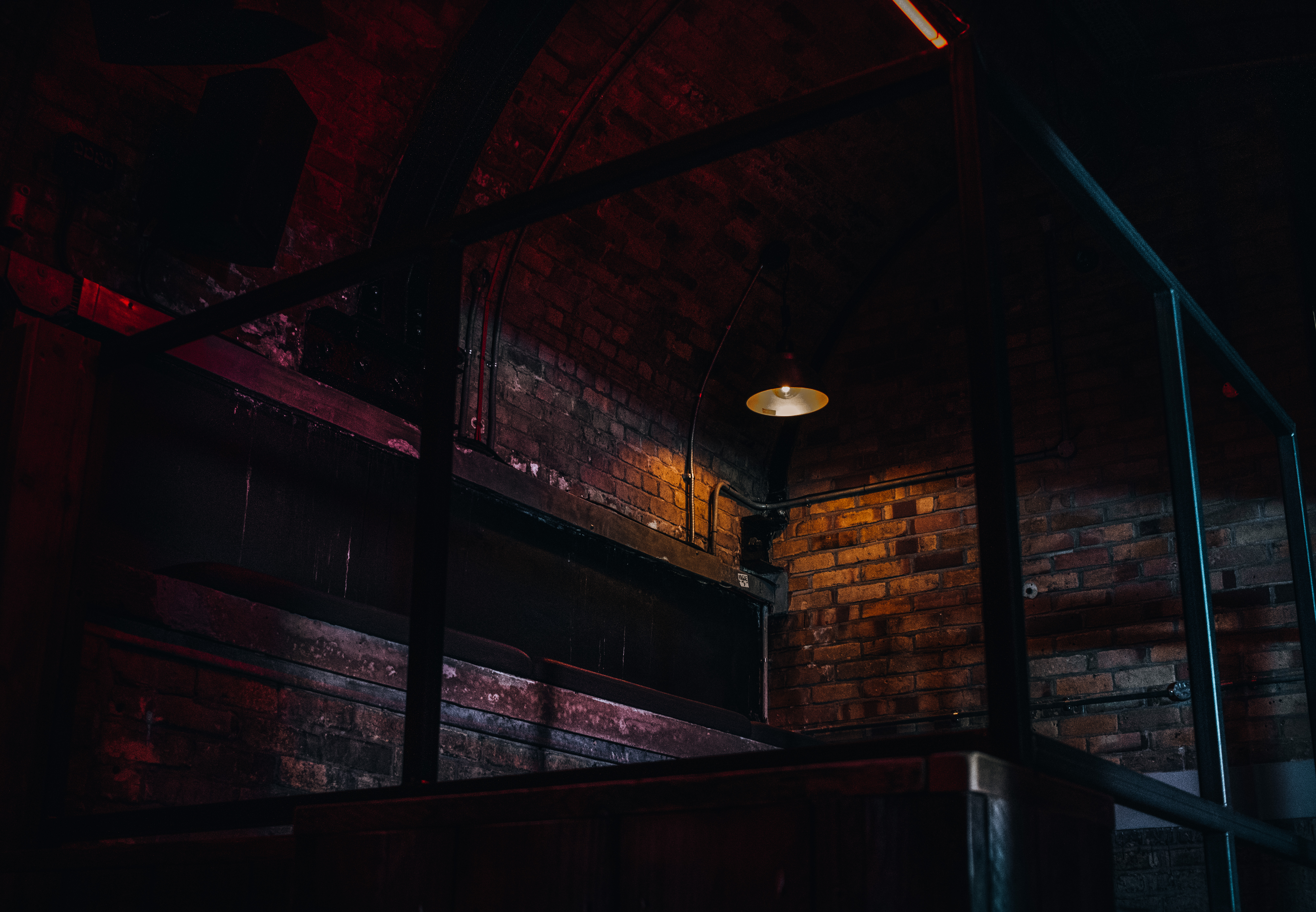 Industrial event space with exposed brick and dramatic lighting for unique gatherings.