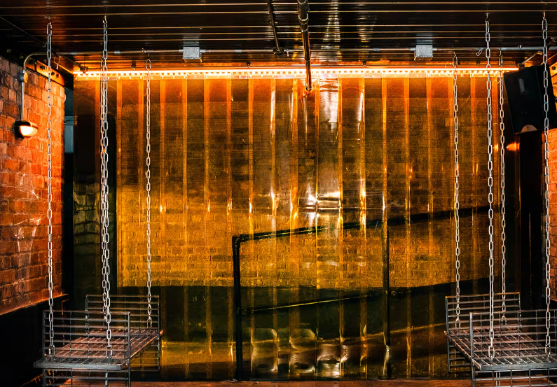 Sunken Bar in Fabric: industrial event space with swings, perfect for networking and gatherings.