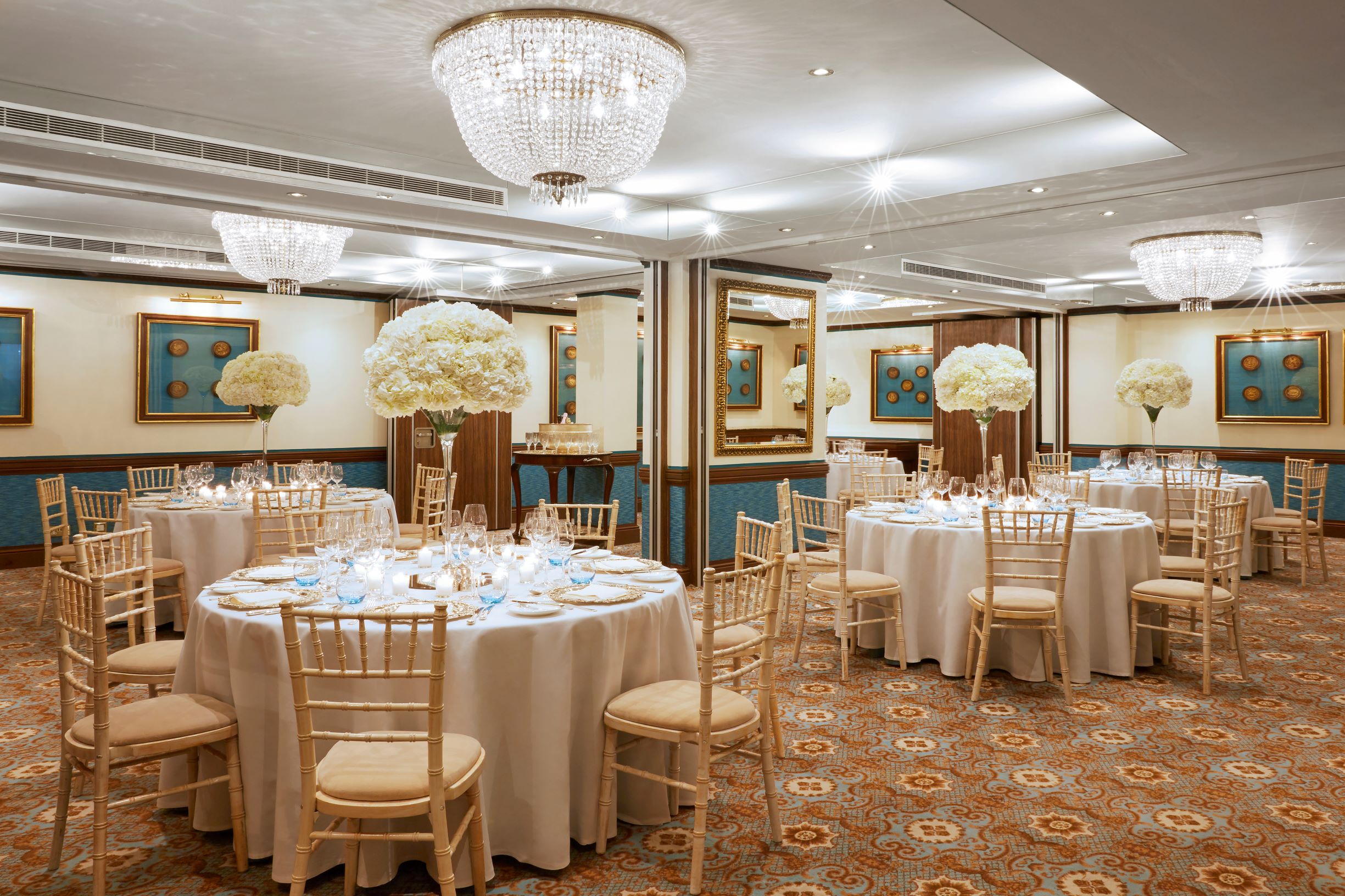 Elegant Van Dyke Suite banquet hall with floral centerpieces, perfect for weddings and events.