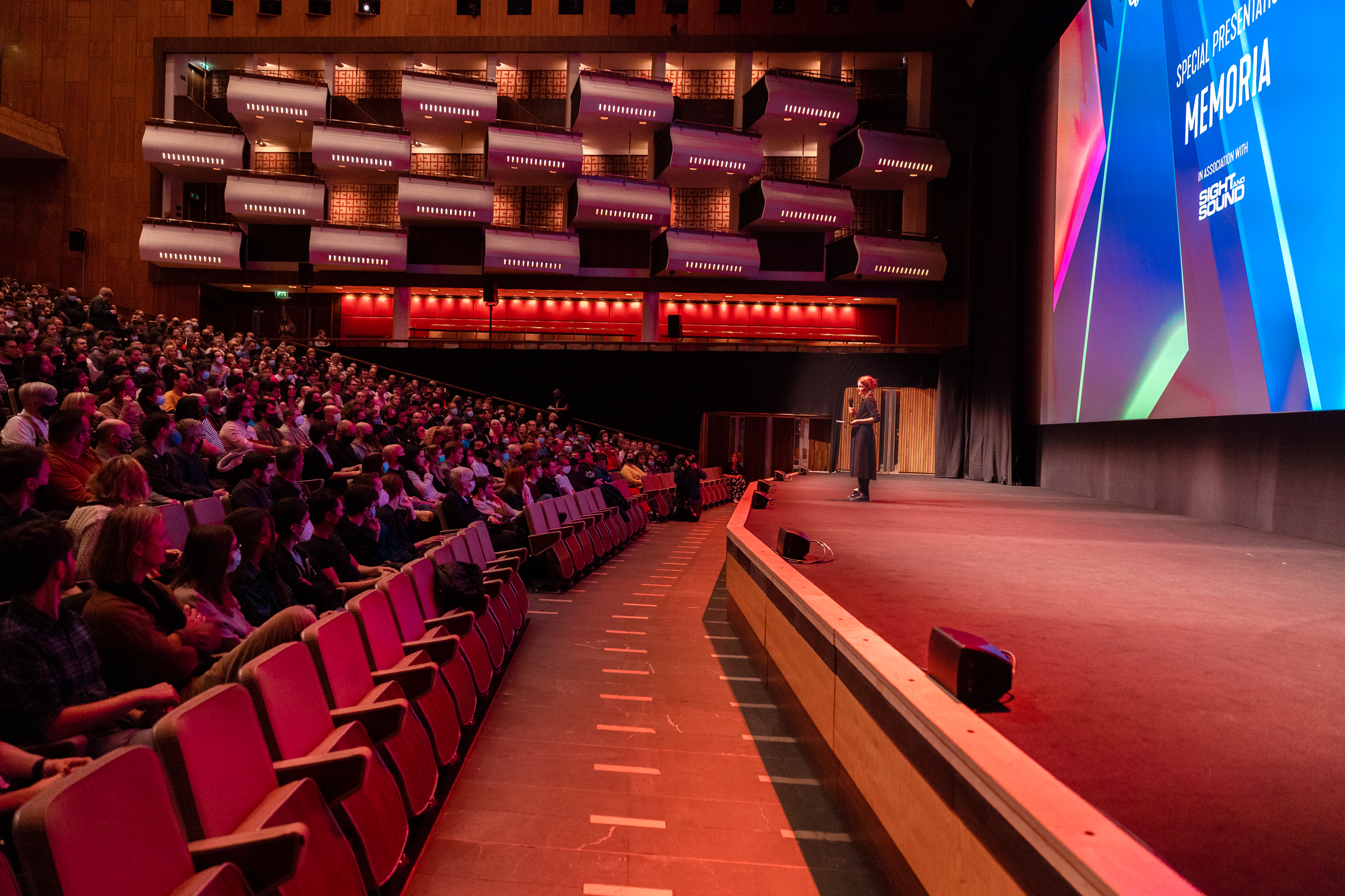 Royal Festival Hall conference with engaging speaker and tiered seating.