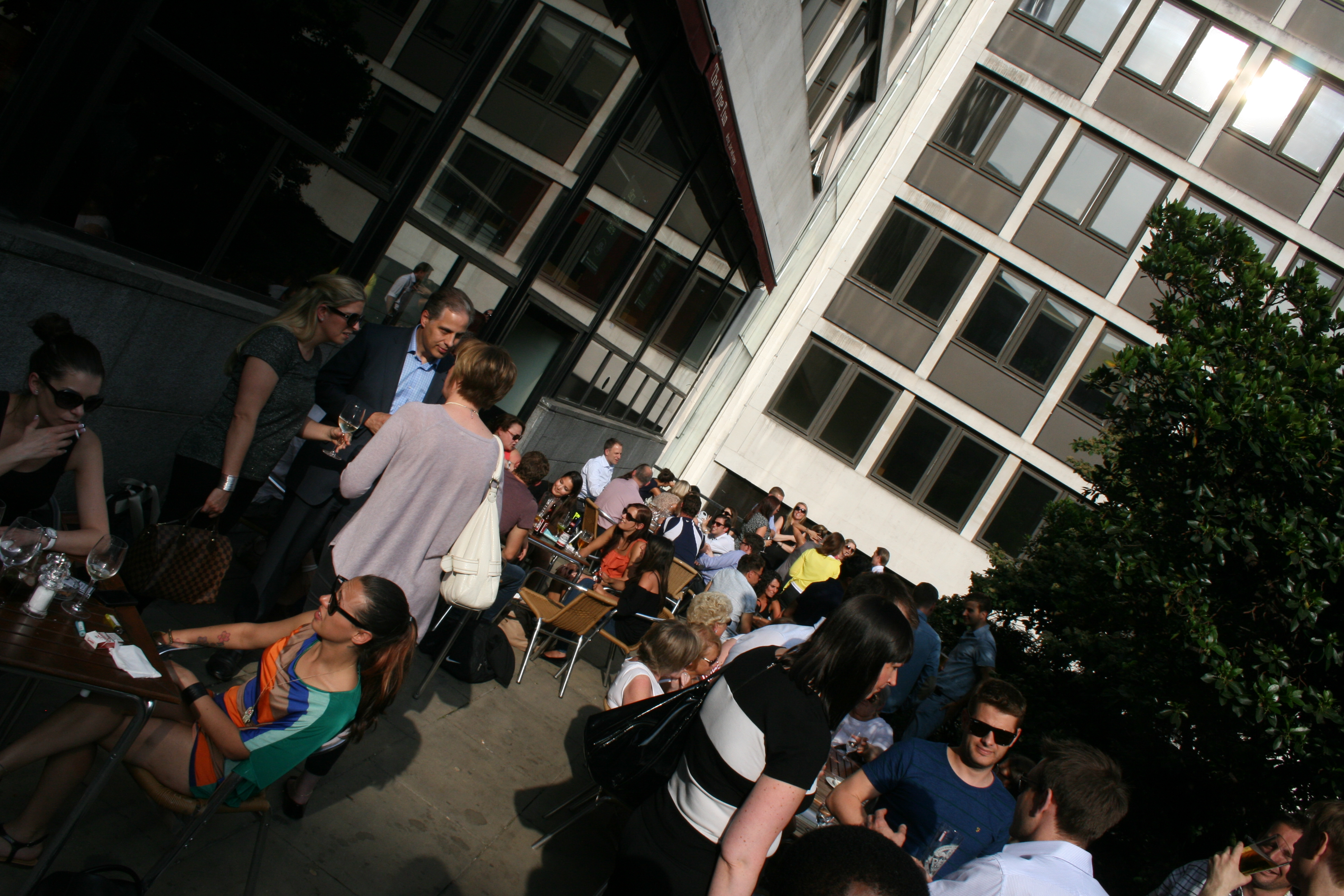 Outdoor networking event in vibrant Back Garden with inviting natural light.