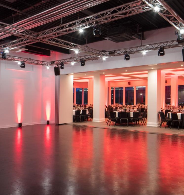 Elegant event space at Queenhithe, featuring red lighting for weddings and corporate gatherings.