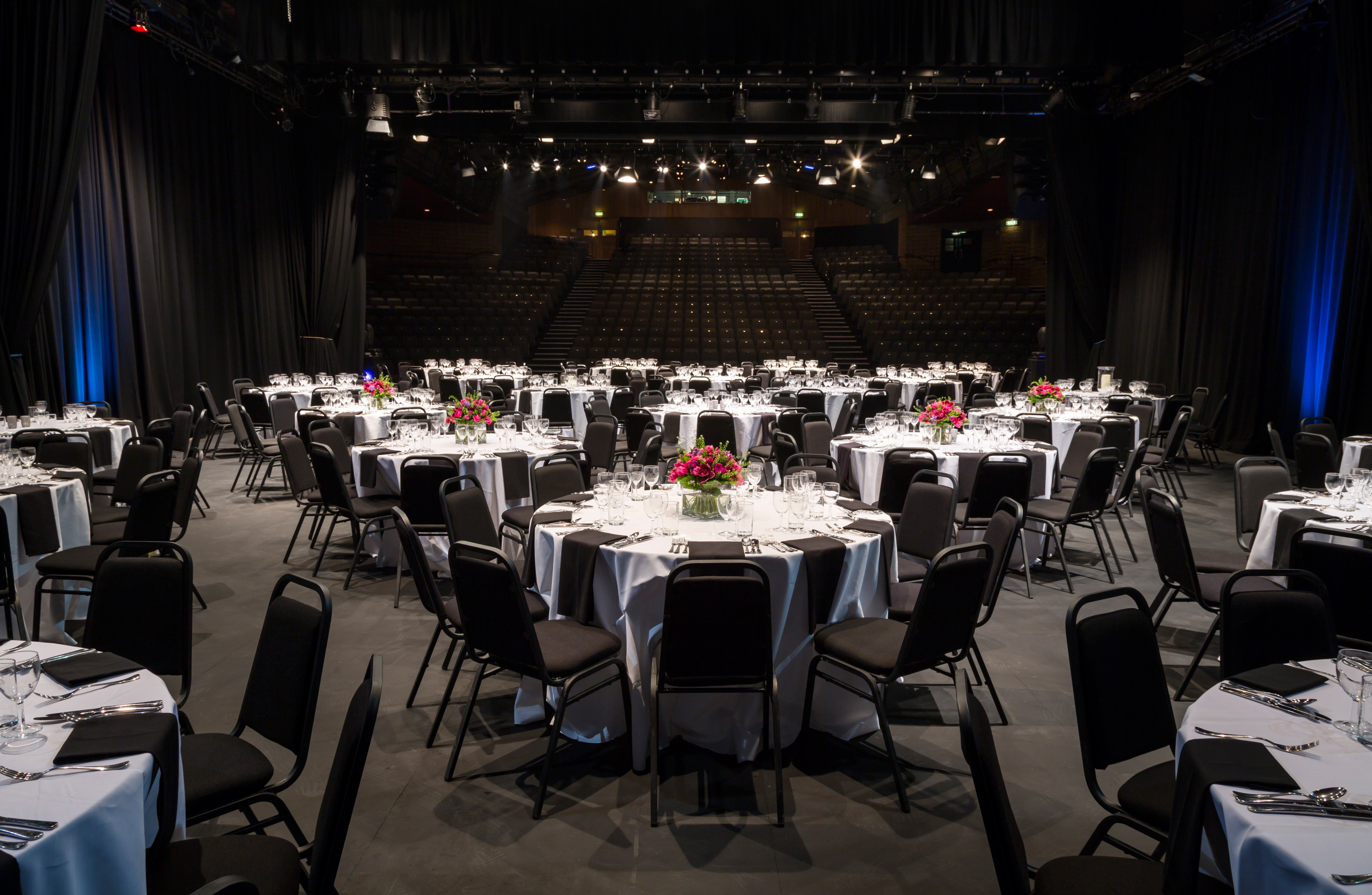 Elegant event space in The Mermaid London with floral centerpieces for networking.