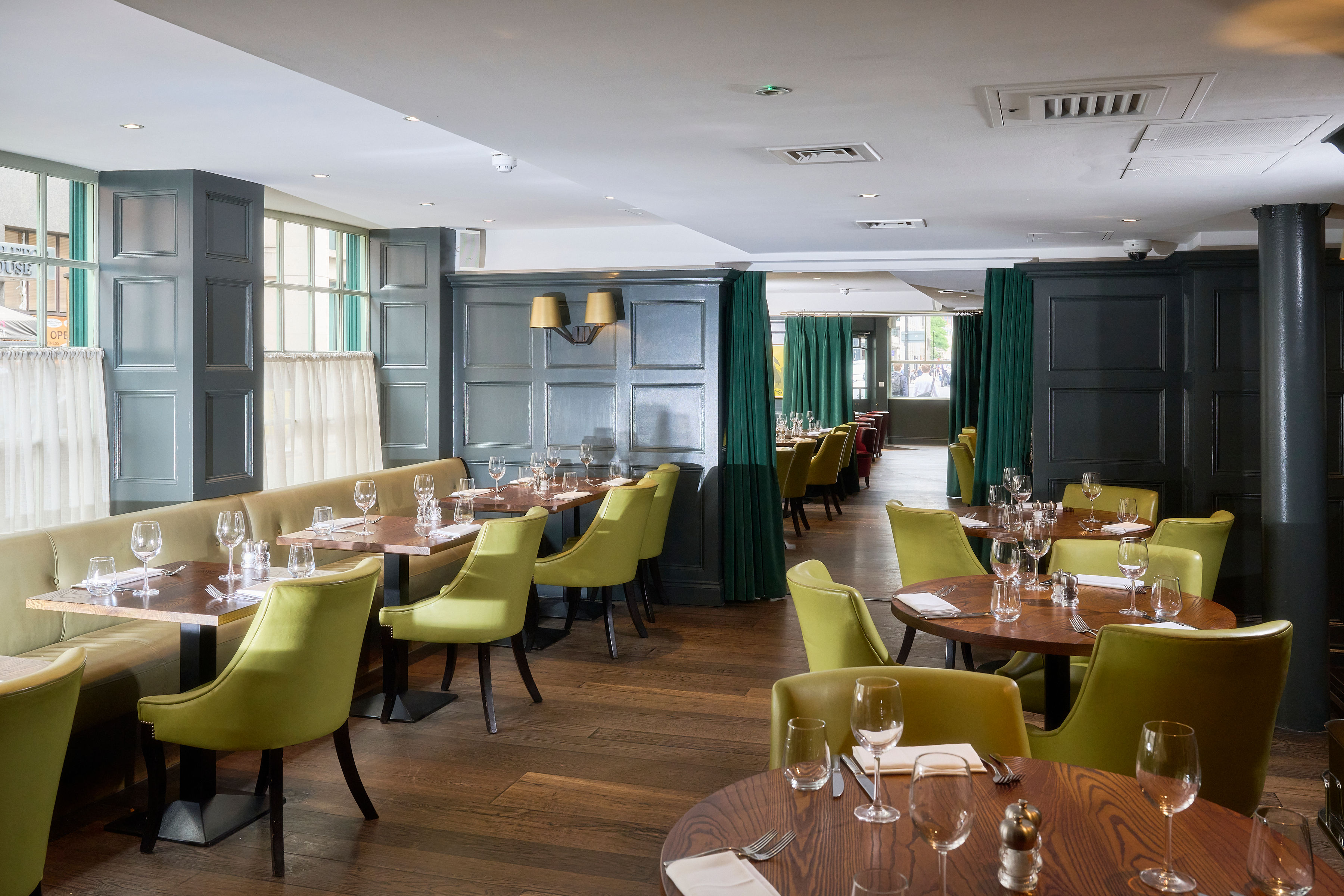 Stylish restaurant venue with green accents for intimate gatherings and corporate events.