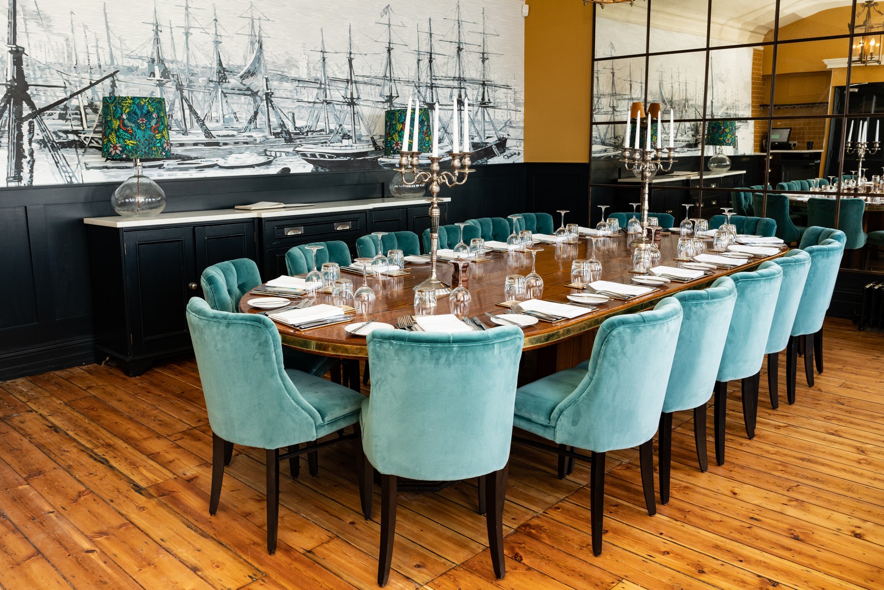 Elegant dining room with turquoise chairs, ideal for corporate dinners and upscale events.