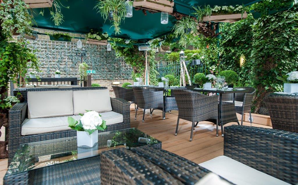 Beach Bar at The Montague: elegant outdoor event space with wicker furniture, perfect for gatherings.