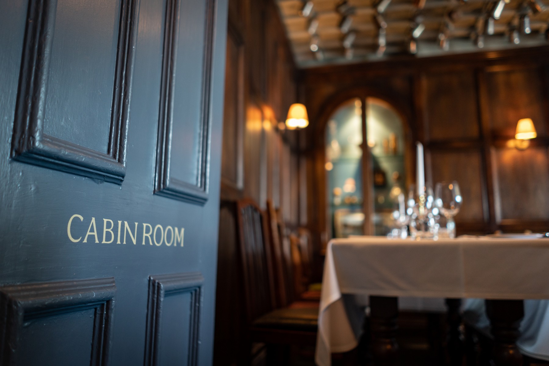 Private dining room with wood paneling for corporate events and intimate gatherings.