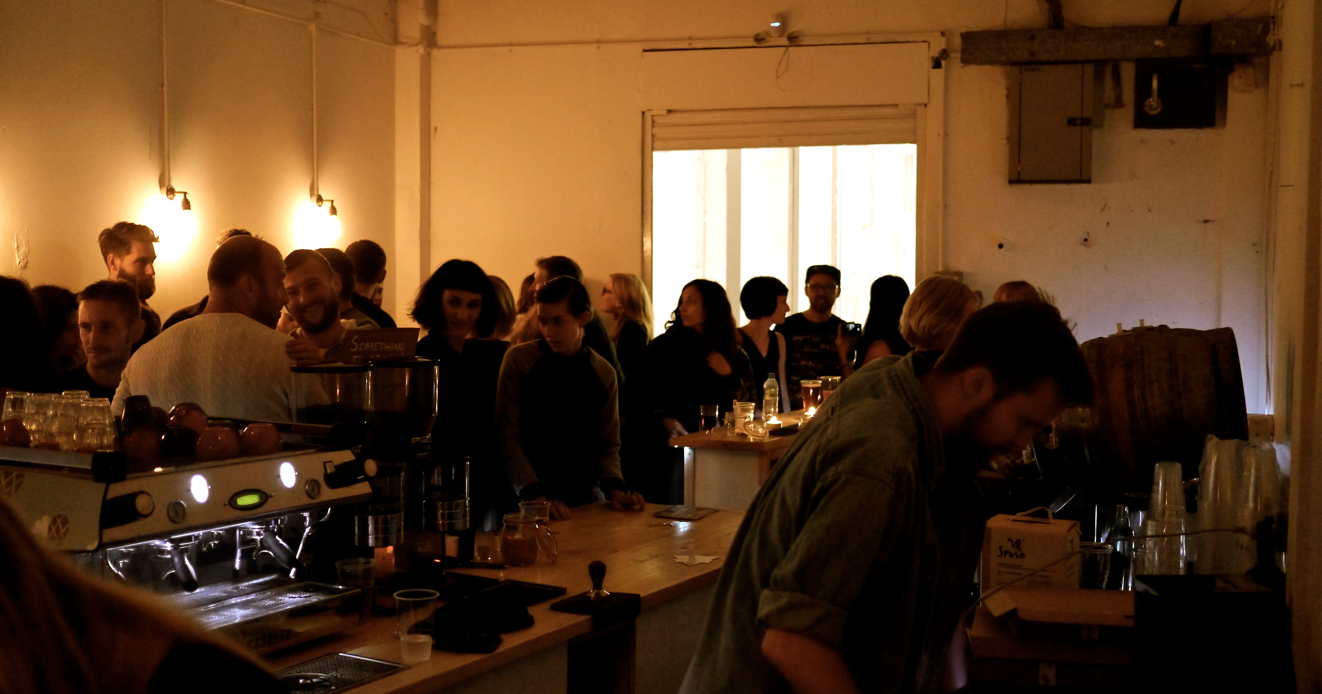 Lively coffee shop gathering with warm lighting, perfect for networking events.