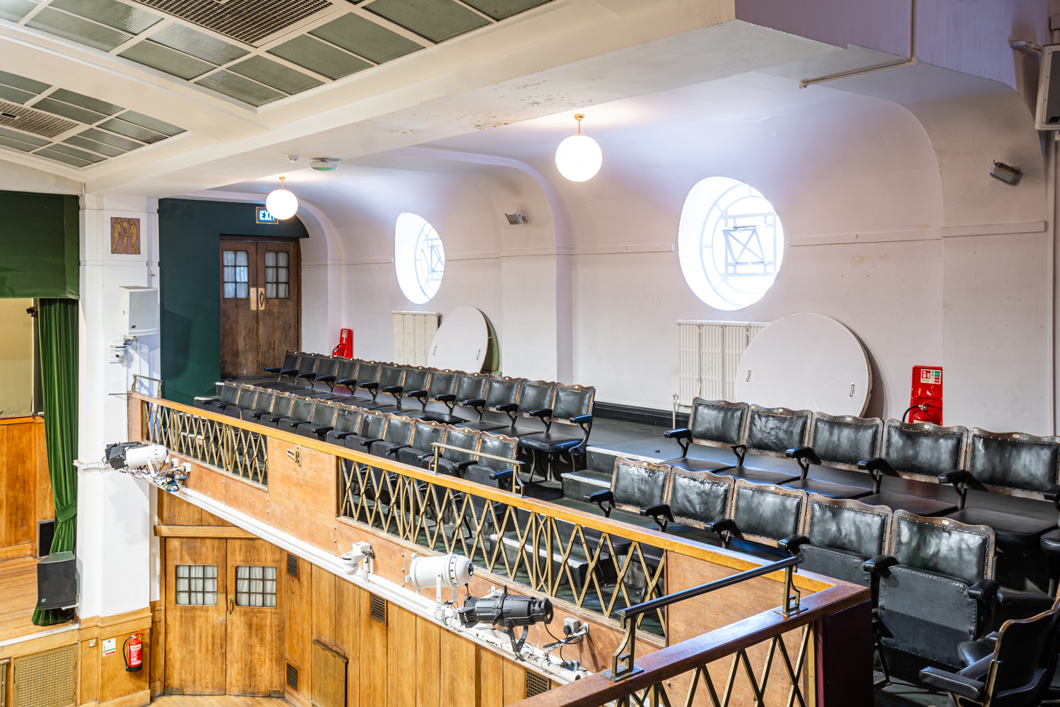 Spacious Main Hall in Conway Hall with tiered seating, perfect for conferences and performances.