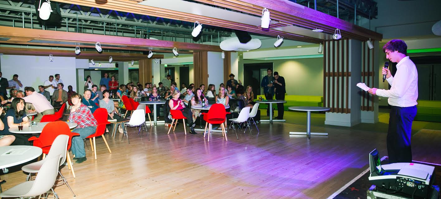 Lively networking event at Guild of Students Liverpool with colorful tables and intimate lighting.