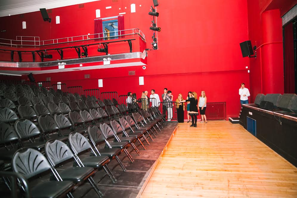 "Stanley Theatre in Liverpool: modern venue with red walls, ideal for conferences and performances."