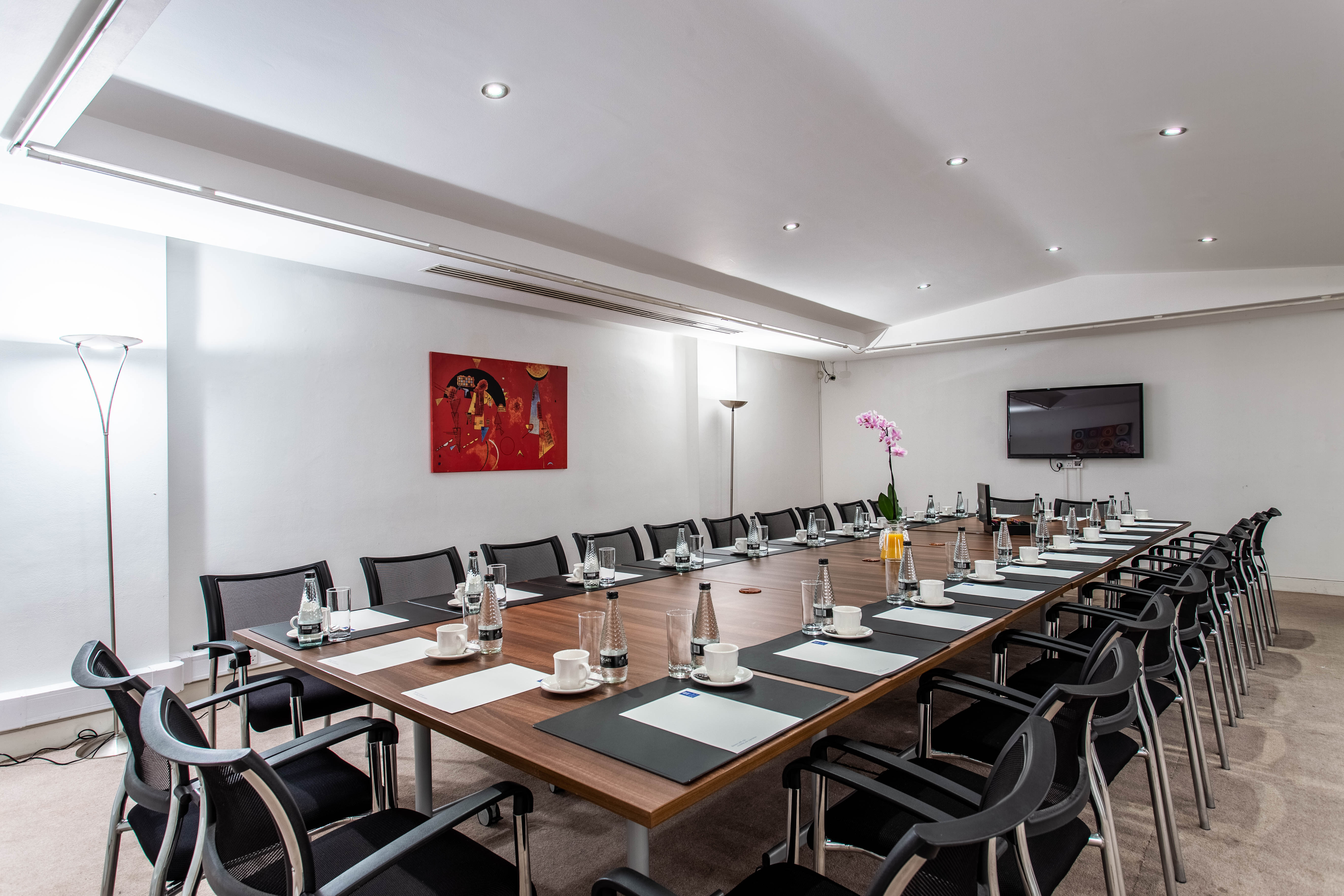 Conference room in Adam House with polished table, ideal for meetings and presentations.