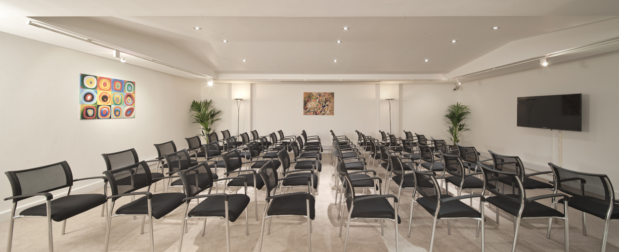 Gallery Room in Adam House: modern meeting space with sleek chairs for workshops and presentations.