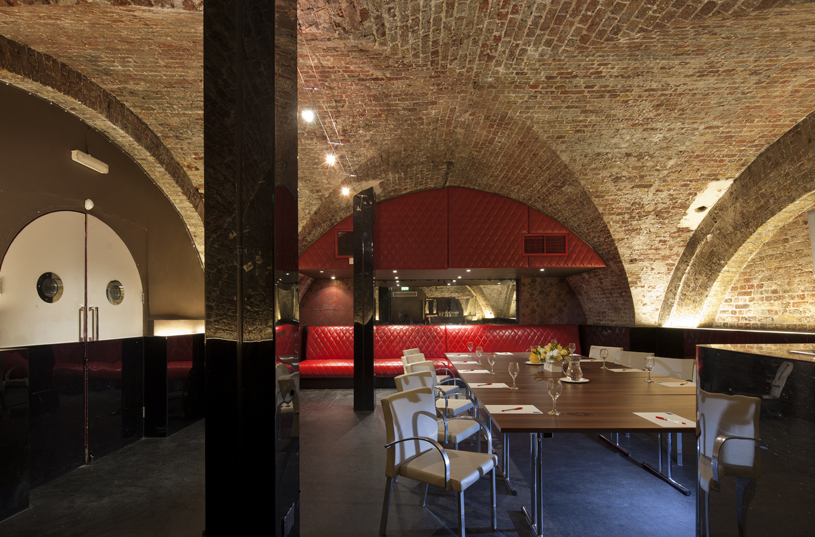 Modern event space with exposed brick arches, ideal for corporate events and private dinners.