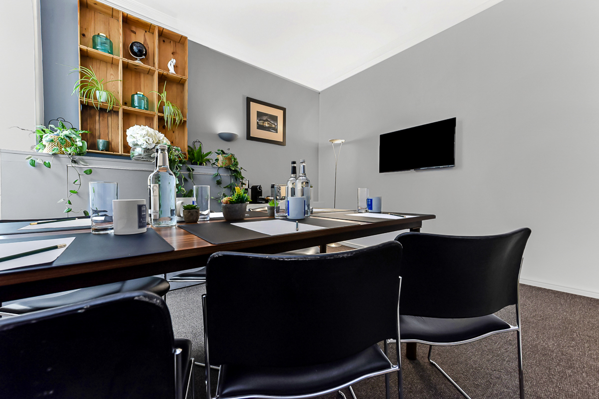 Adam Room in Adam House: modern meeting space with greenery, ideal for brainstorming sessions.