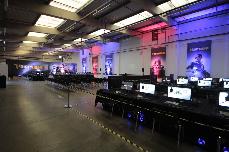 Gaming tournament setup at U Block, featuring rows of computers and ambient lighting.