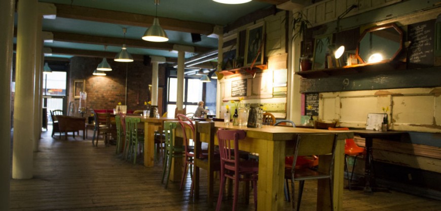 Cozy dining space with wooden tables, ideal for informal meetings and team events.