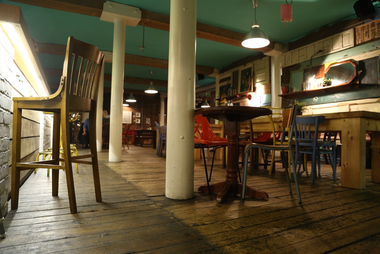 Rustic venue with colorful chairs, ideal for casual meetings and networking events.