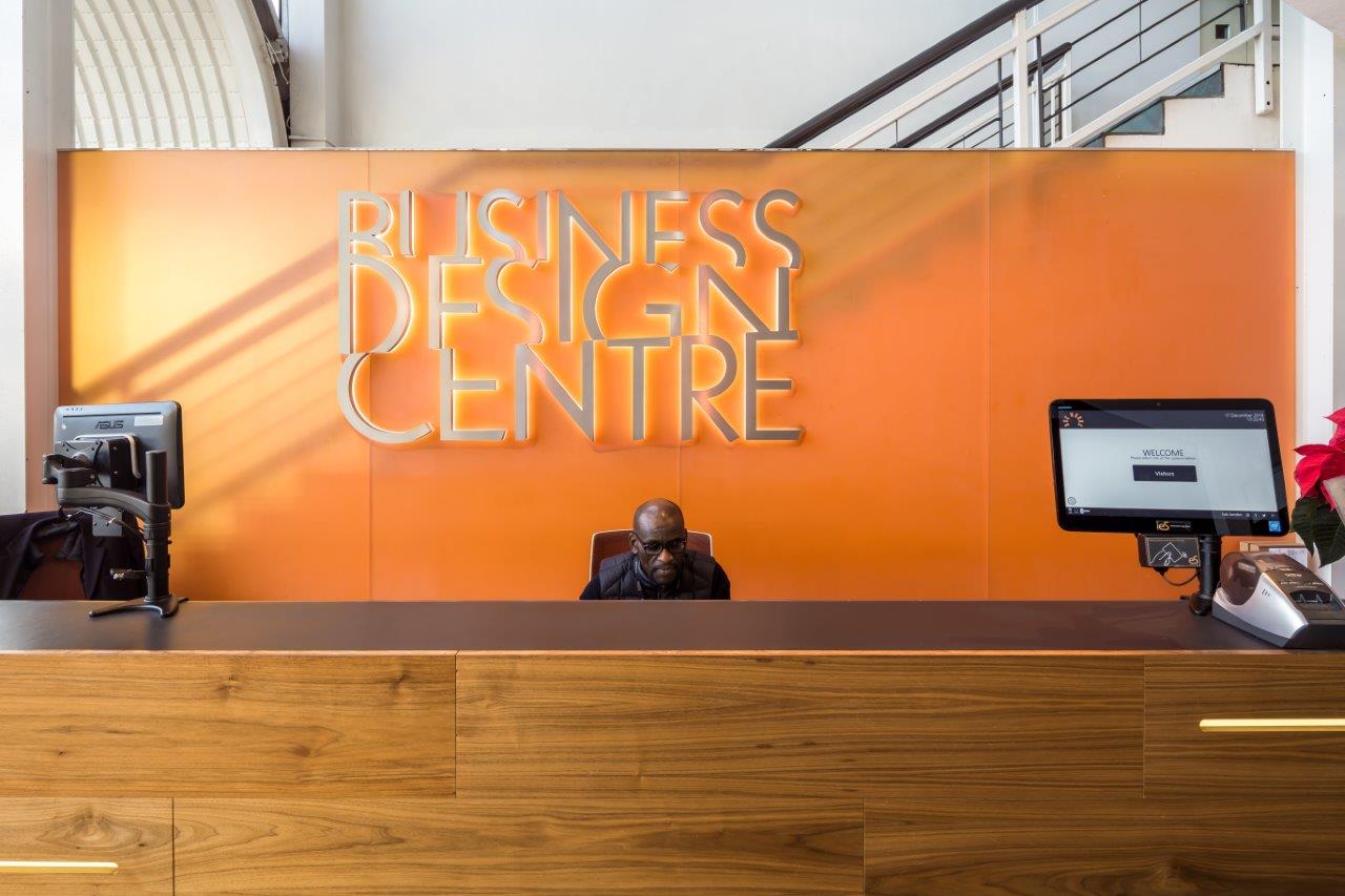 Sleek reception area with wooden desk at Business Design Centre for events and meetings.