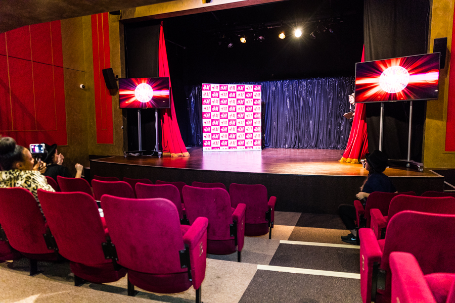 Theatre in KidZania London with stage, screens, and plush seating for events.