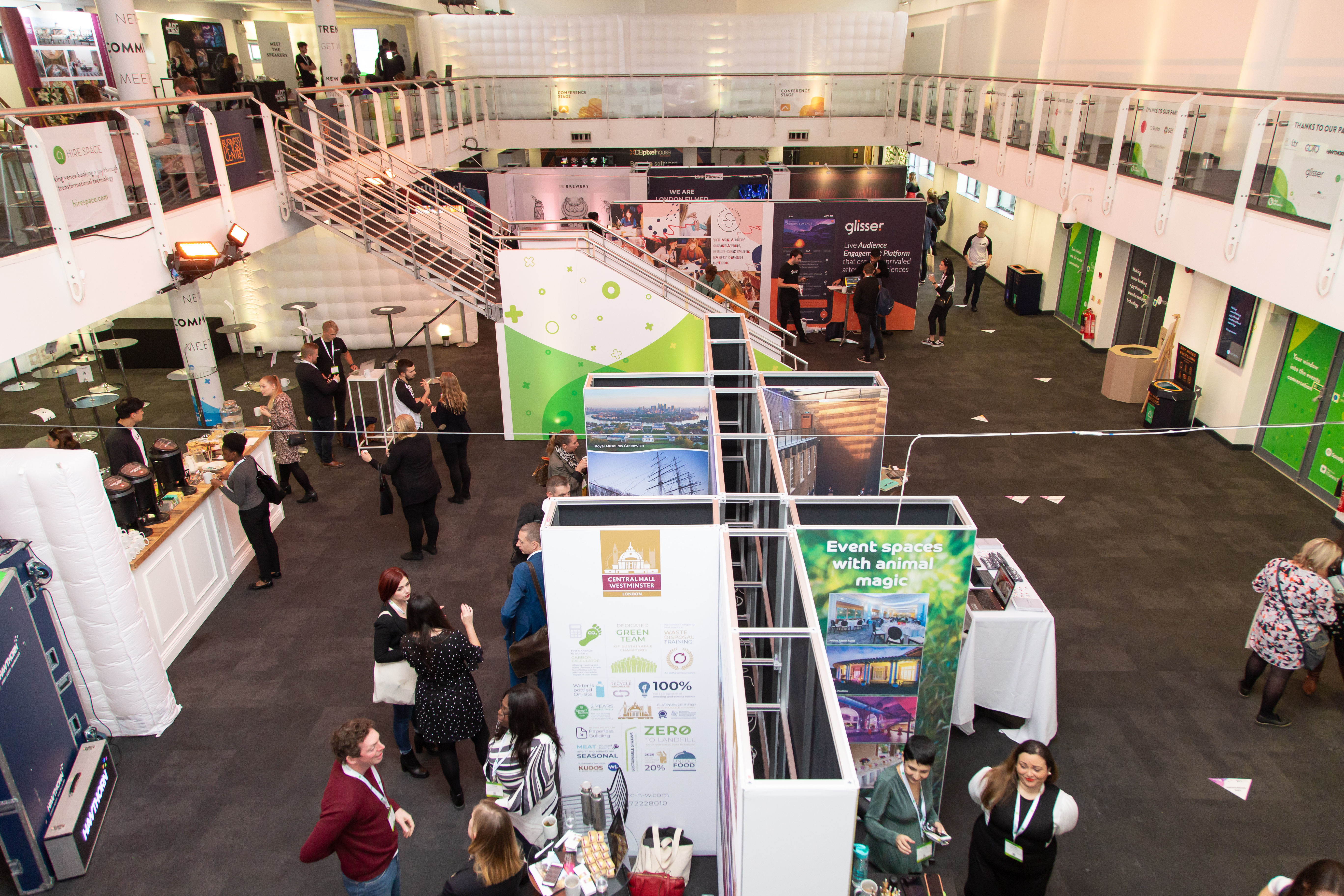 "Gallery Hall at Business Design Centre, vibrant trade show with networking booths."