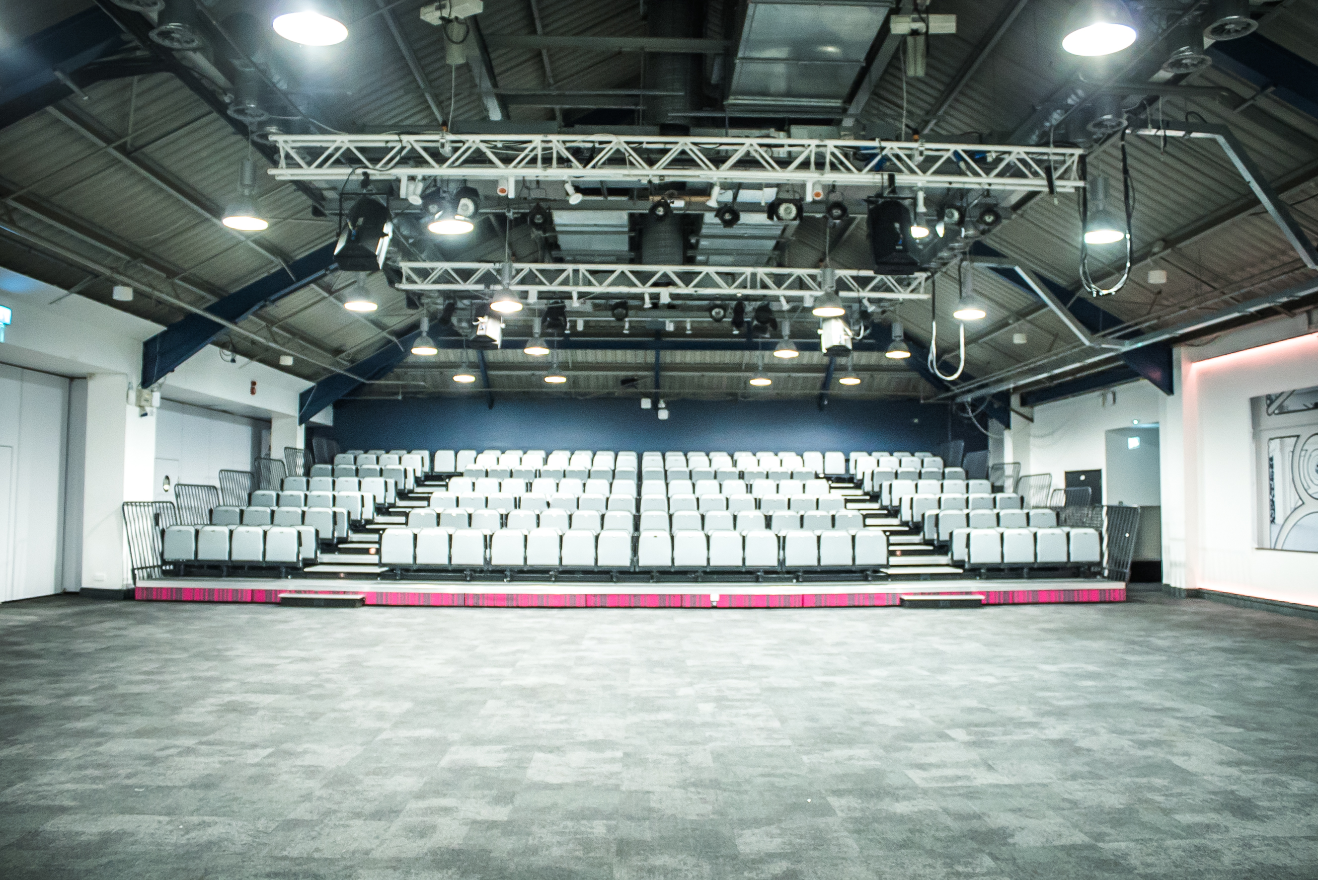 Auditorium with tiered seating, ideal for corporate events and performances.