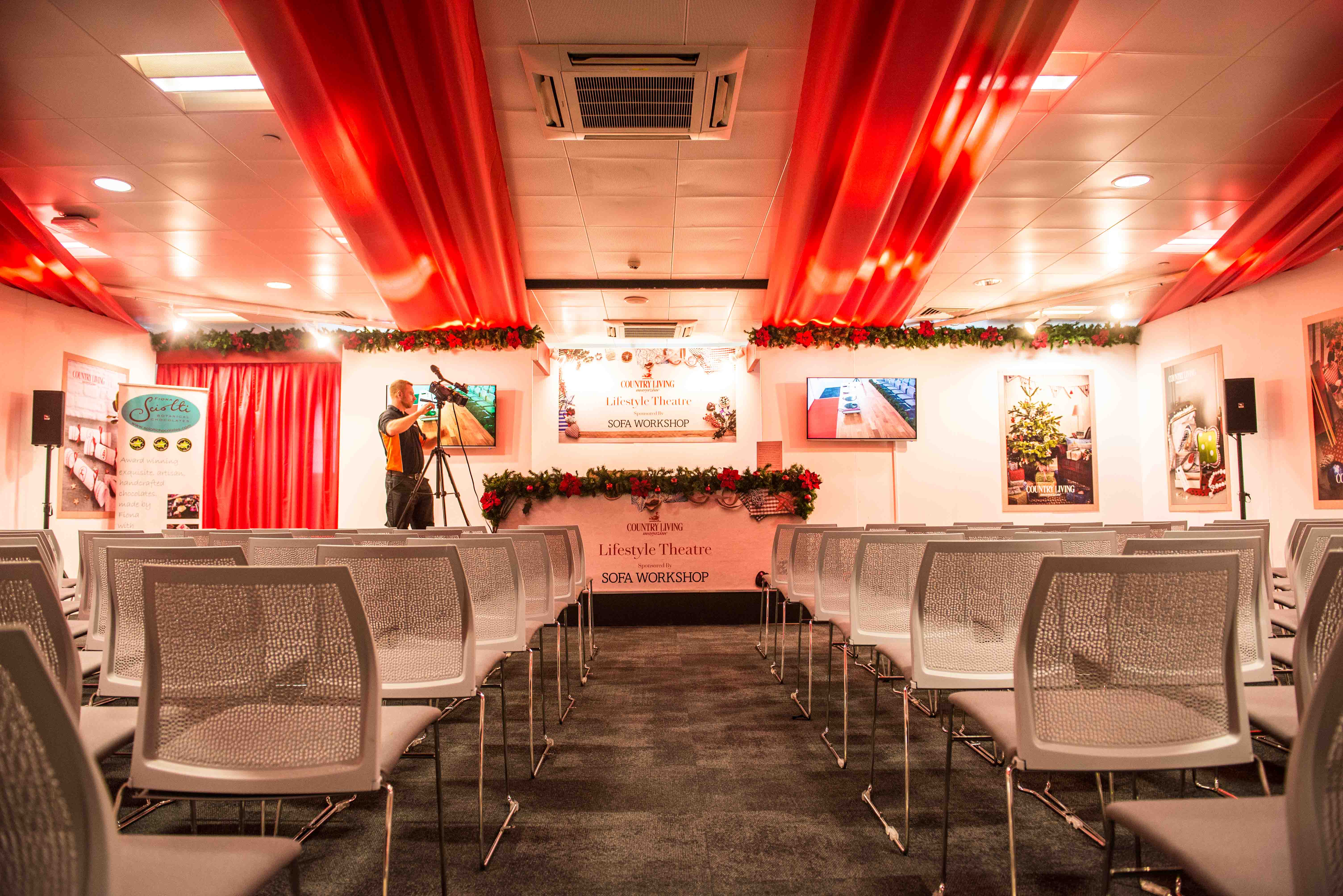 Event space in Business Design Centre with modern chairs and festive decor for presentations.