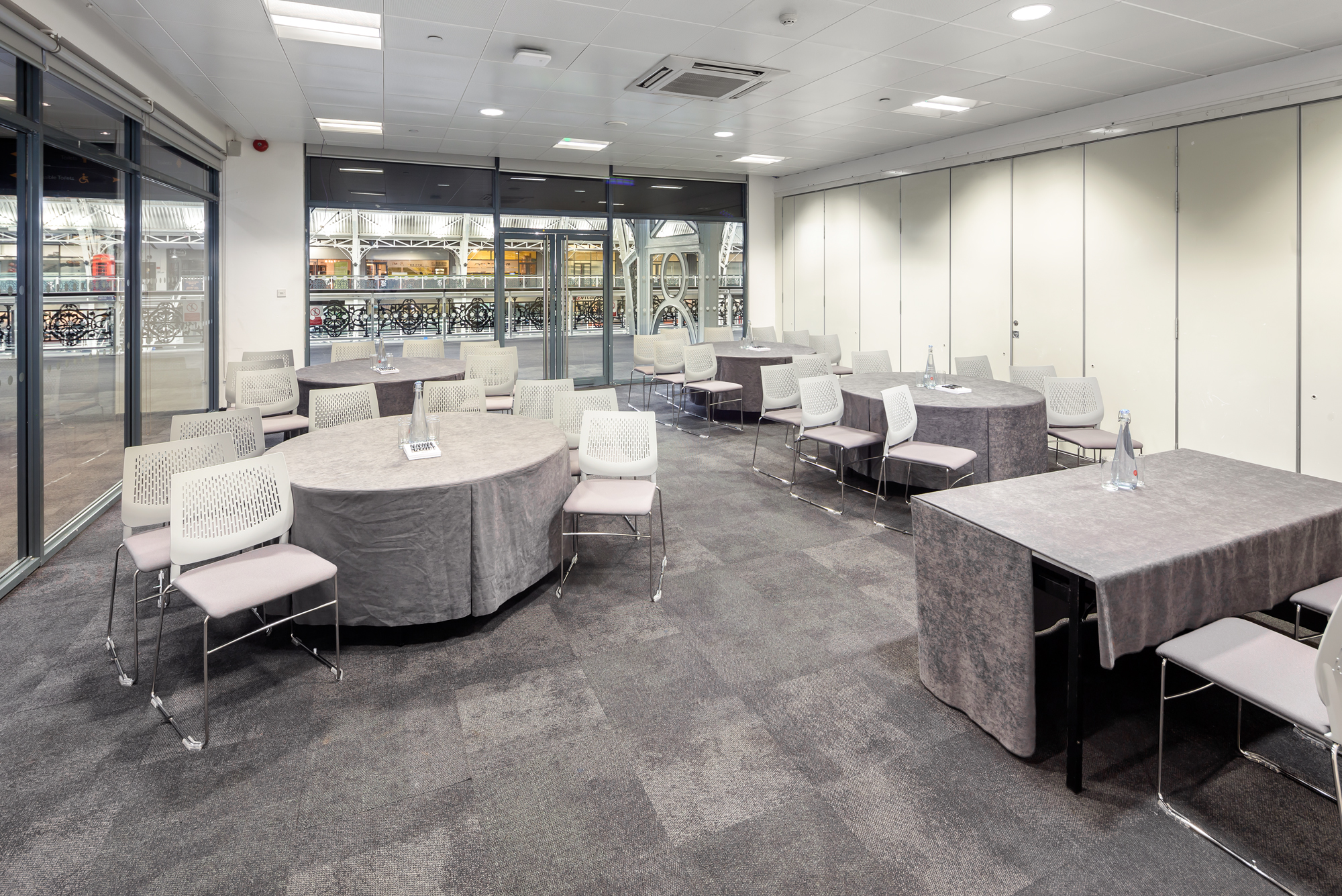 Versatile meeting space with natural light for workshops and networking events.