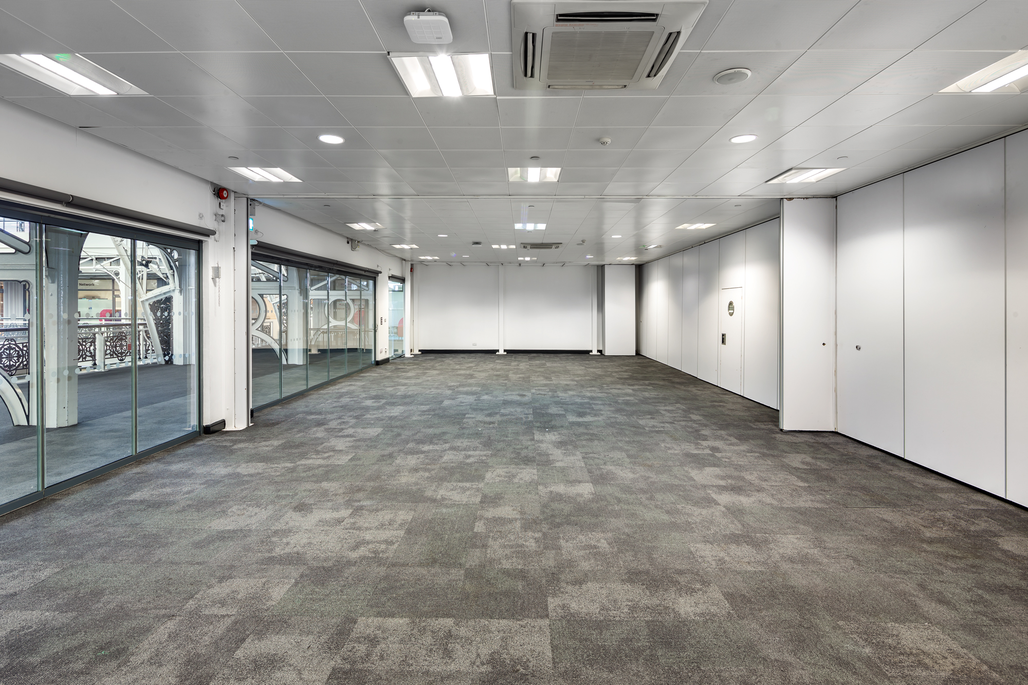 Versatile event space with natural light, ideal for meetings and corporate functions.