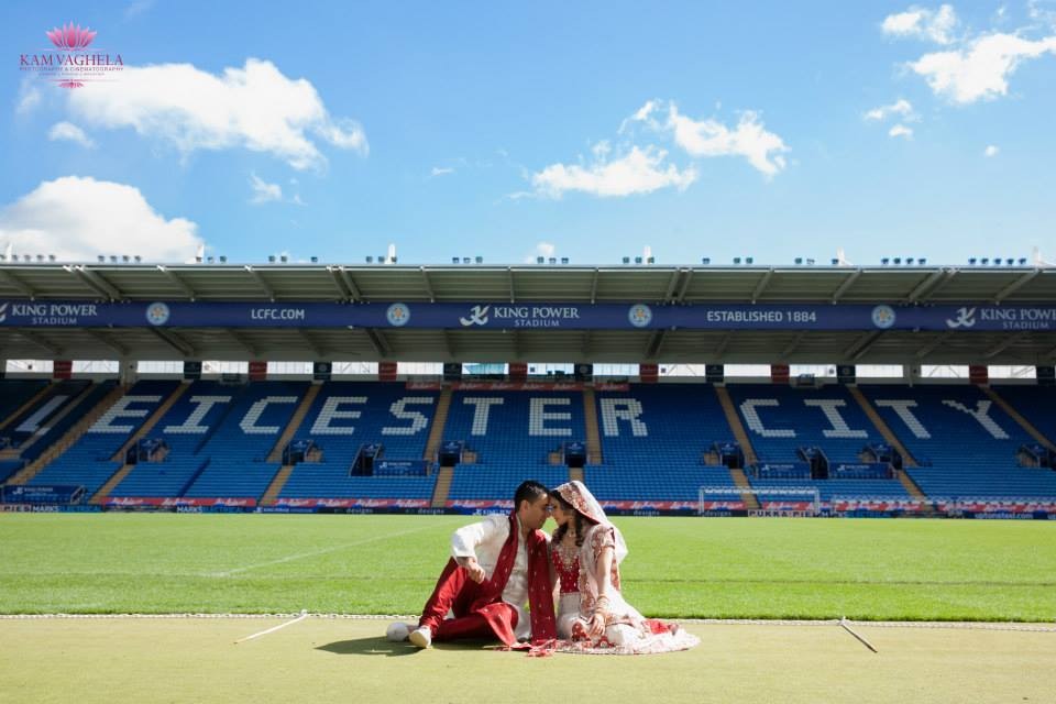 Couple in traditional attire at Walkers Hall, King Power Stadium for unique wedding event.