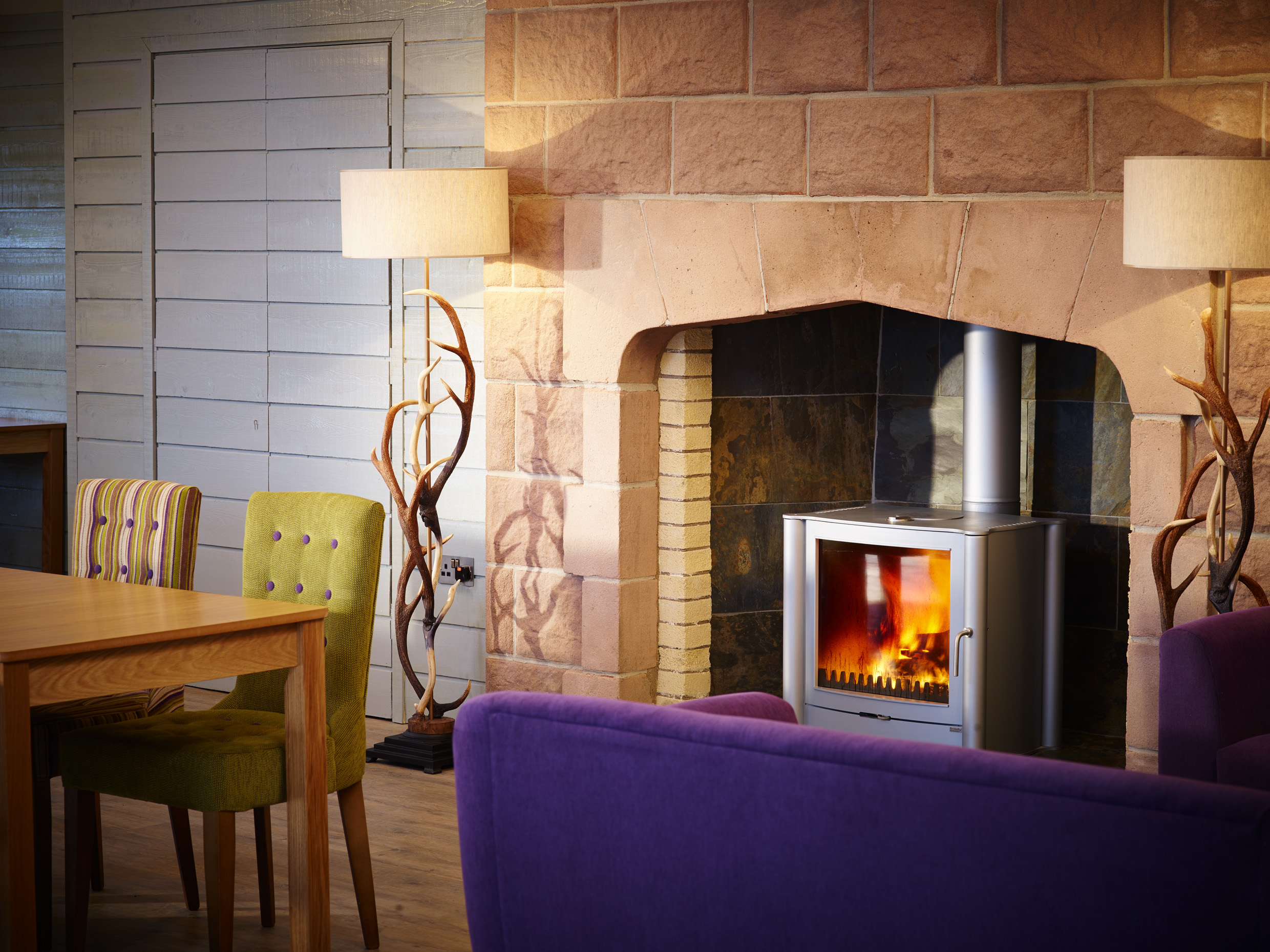 Cozy Forest Pavilion meeting space with fireplace, ideal for team-building events.