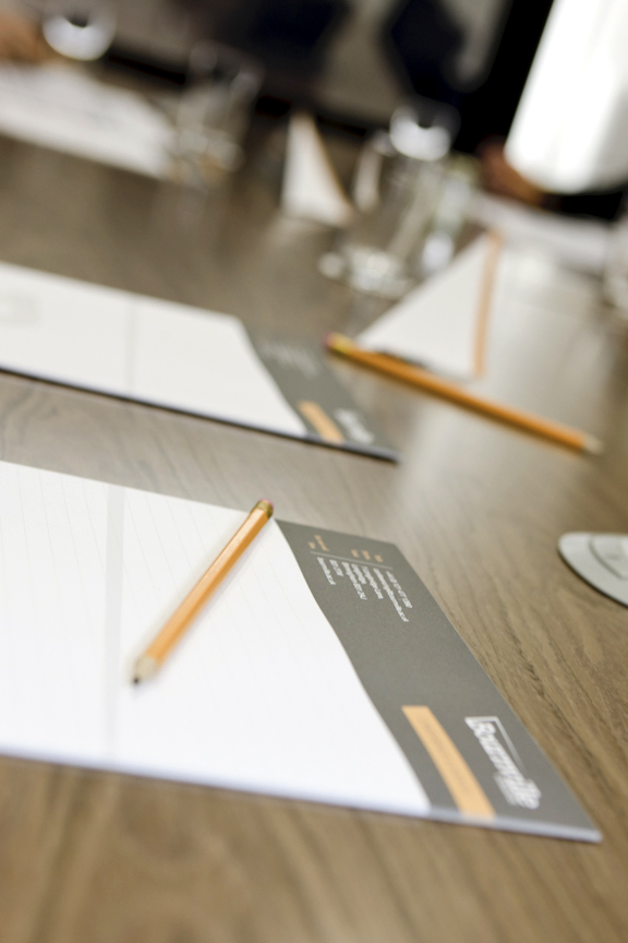 Cofton Suite meeting setup with polished table, notepads for professional events.