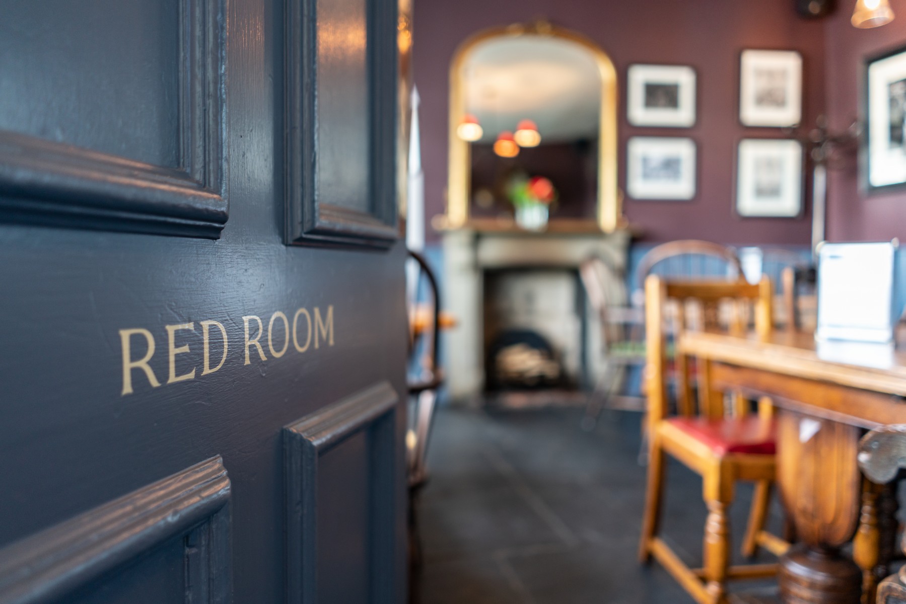 Cozy Red Room venue with rustic decor for intimate meetings and small events.