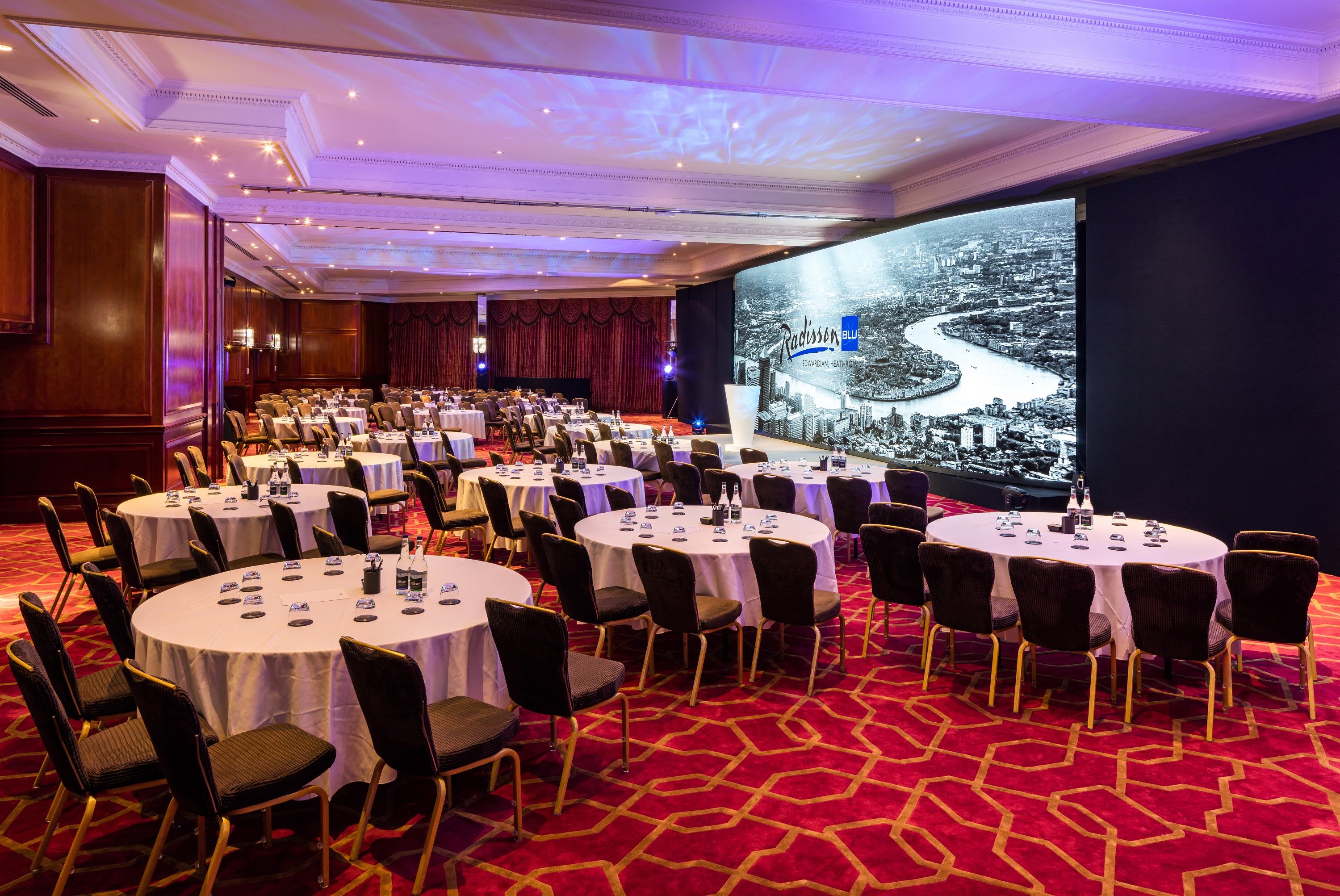 Commonwealth Suite at Radisson Blu Heathrow, elegant round tables for meetings and banquets.