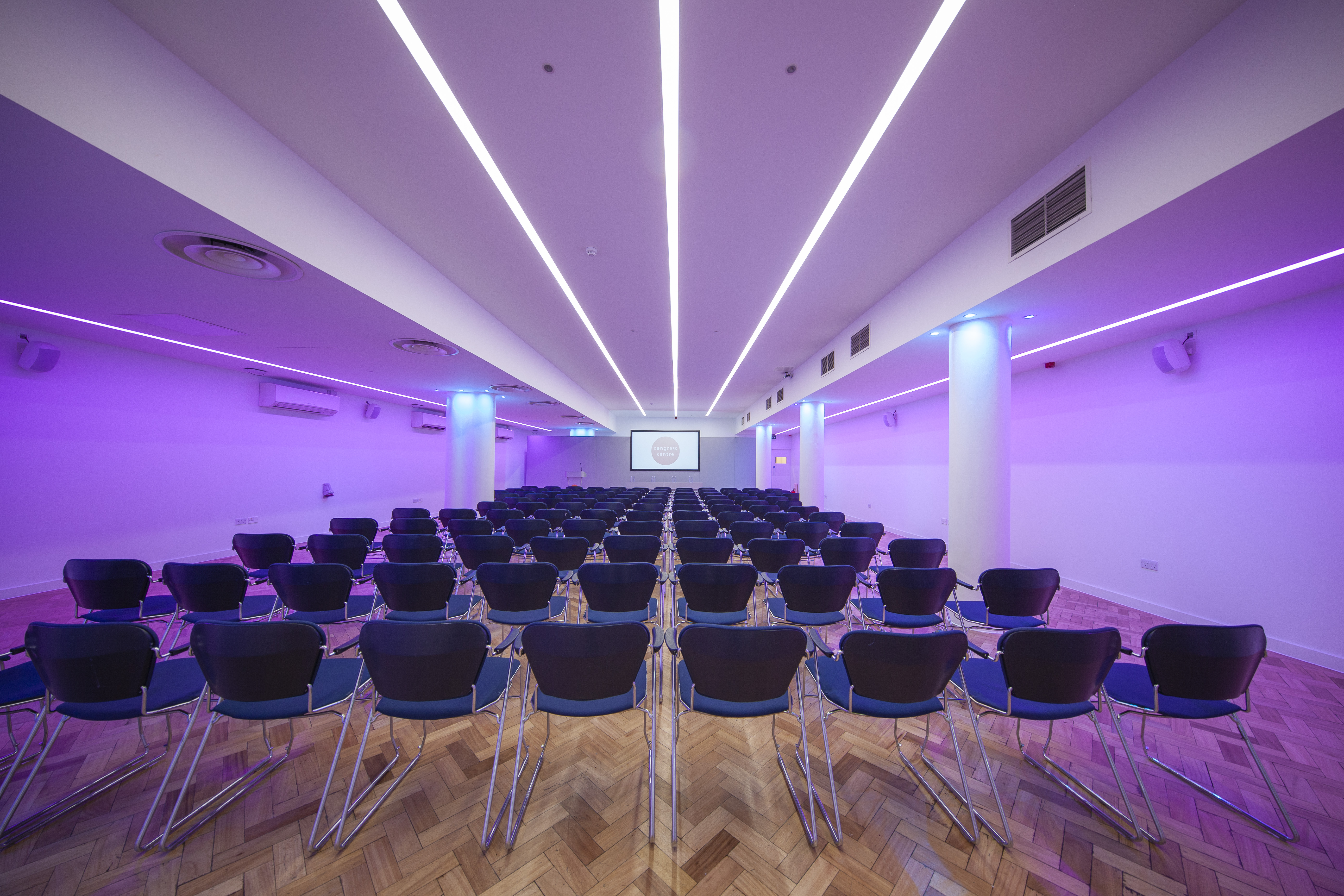 Theater-style Congress Suite with LED lighting for corporate presentations and event venue rental.