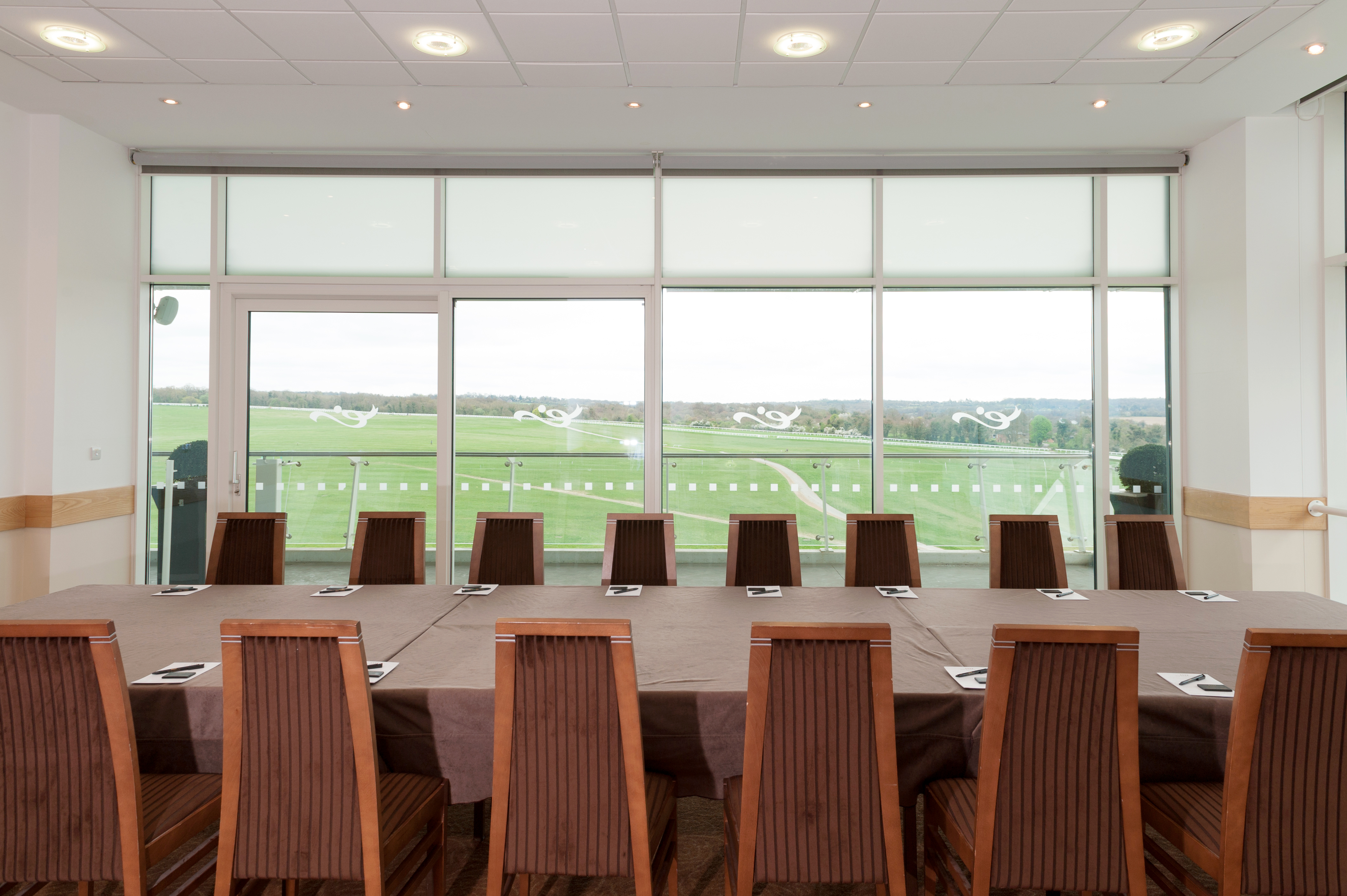 Duchess's Double Box at Epsom Downs: bright meeting room with large table for corporate events.
