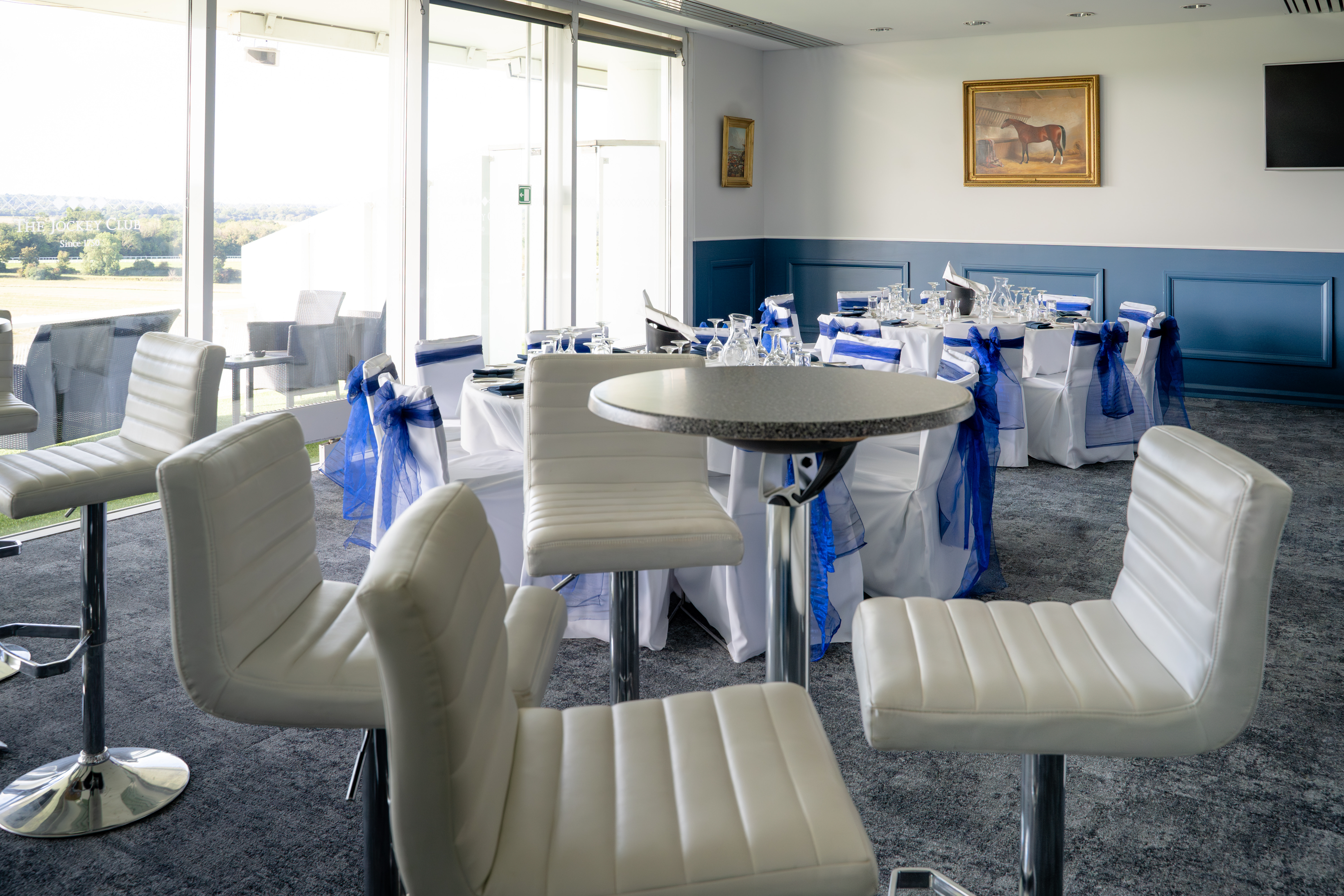 The Boardroom at Epsom Downs Racecourse with modern seating for events and meetings.